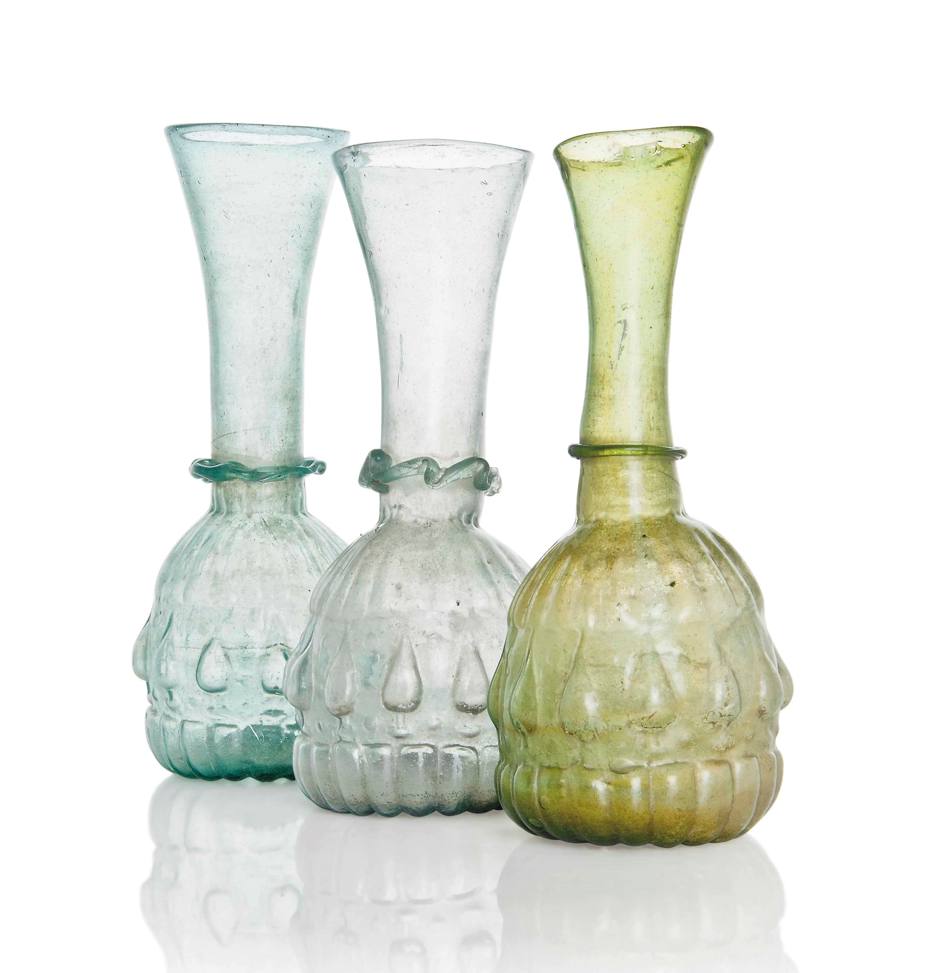 THREE LATE SAFAVID OR QAJAR MOULD-BLOWN GLASS BOTTLES