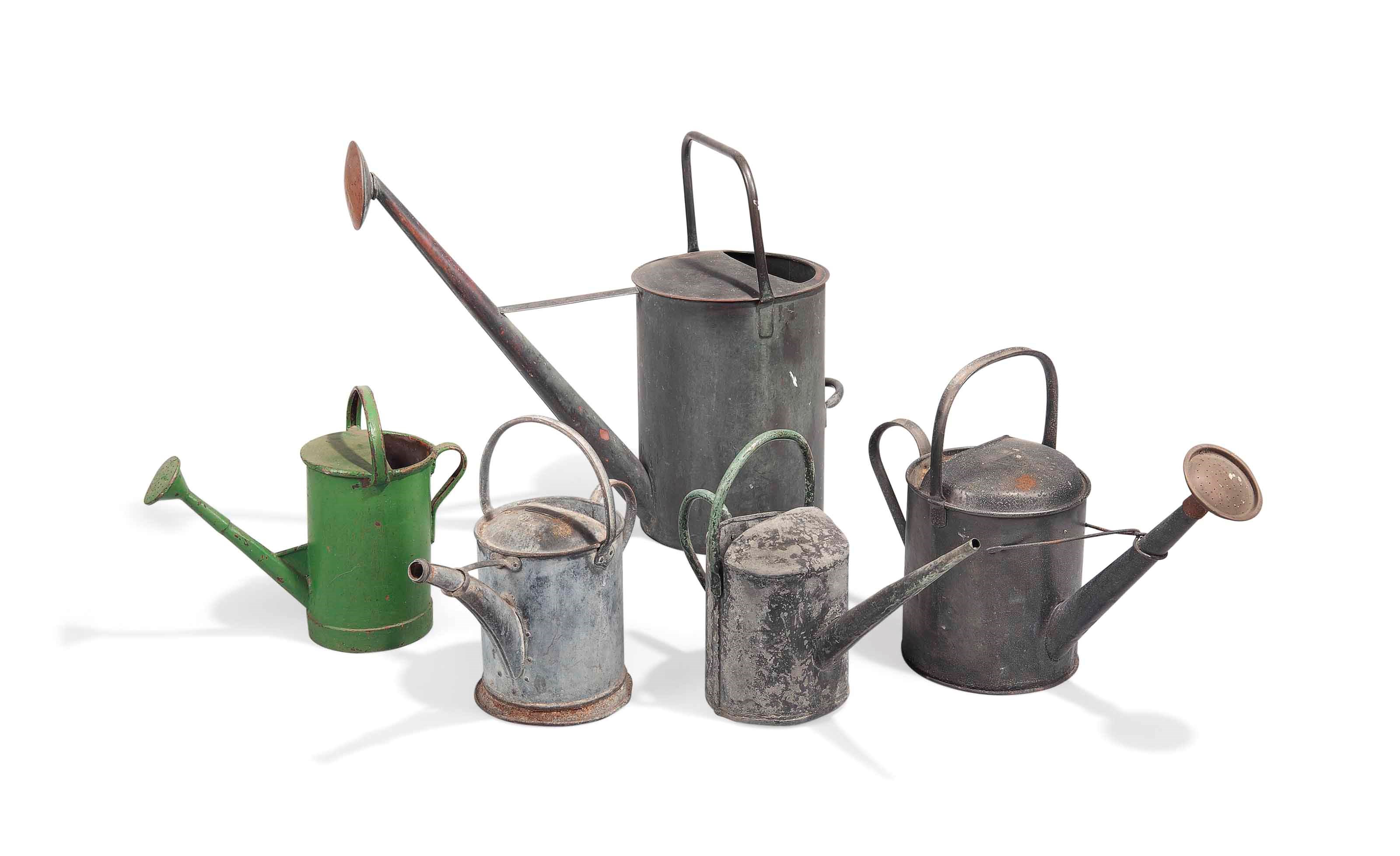 A GROUP OF FIVE BASE METAL WATERING CANS