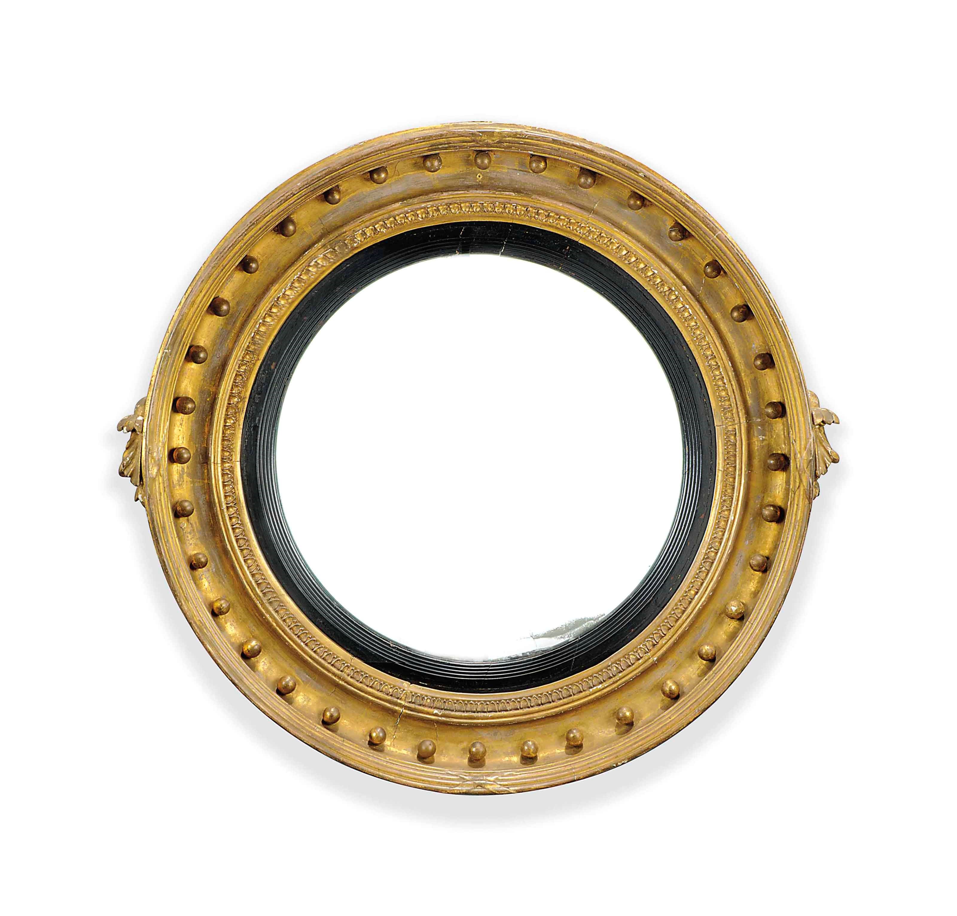 A REGENCY GILTWOOD AND COMPOSITION CONVEX MIRROR