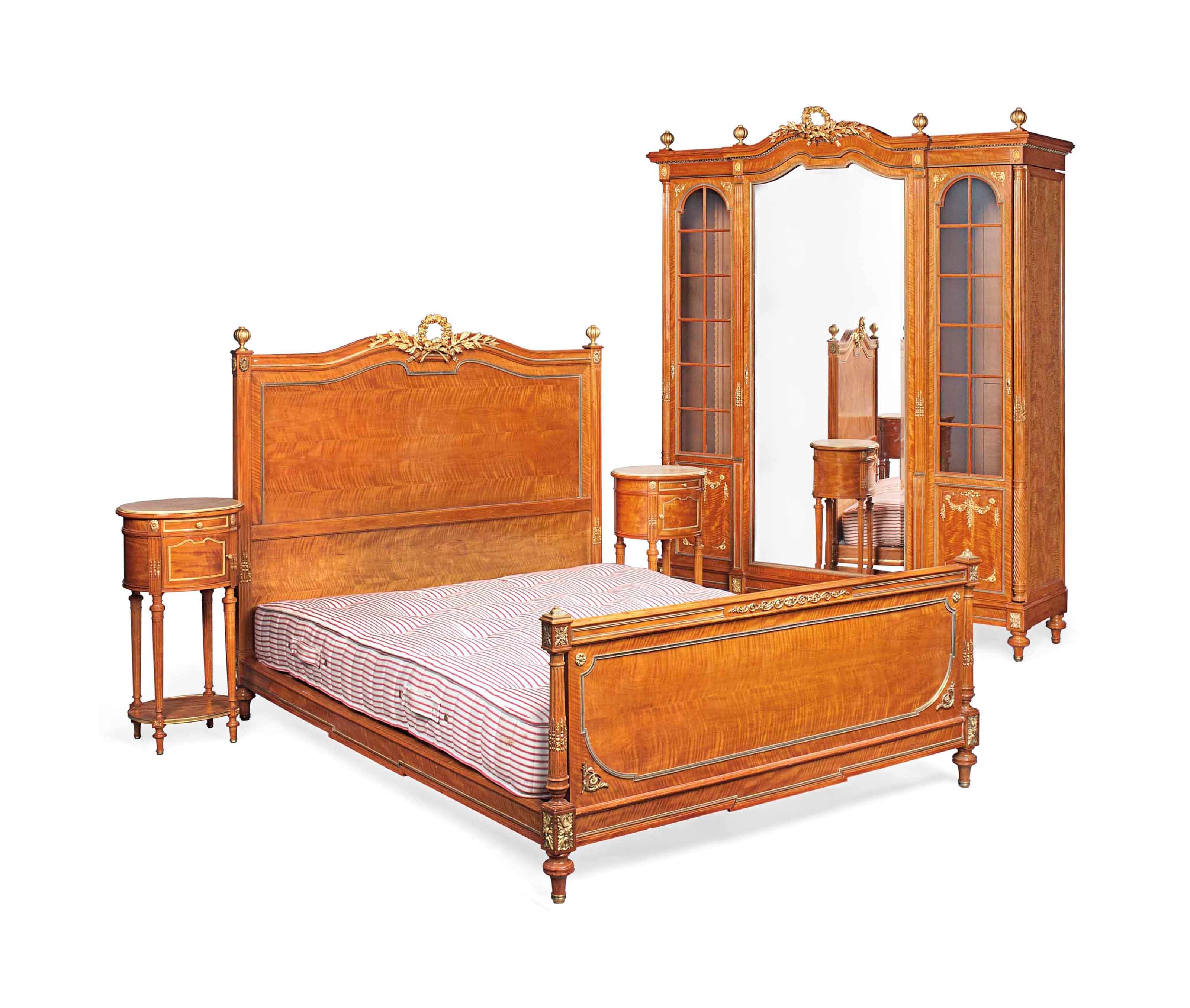 A FRENCH ORMOLU-MOUNTED SATINWOOD BEDROOM SUITE