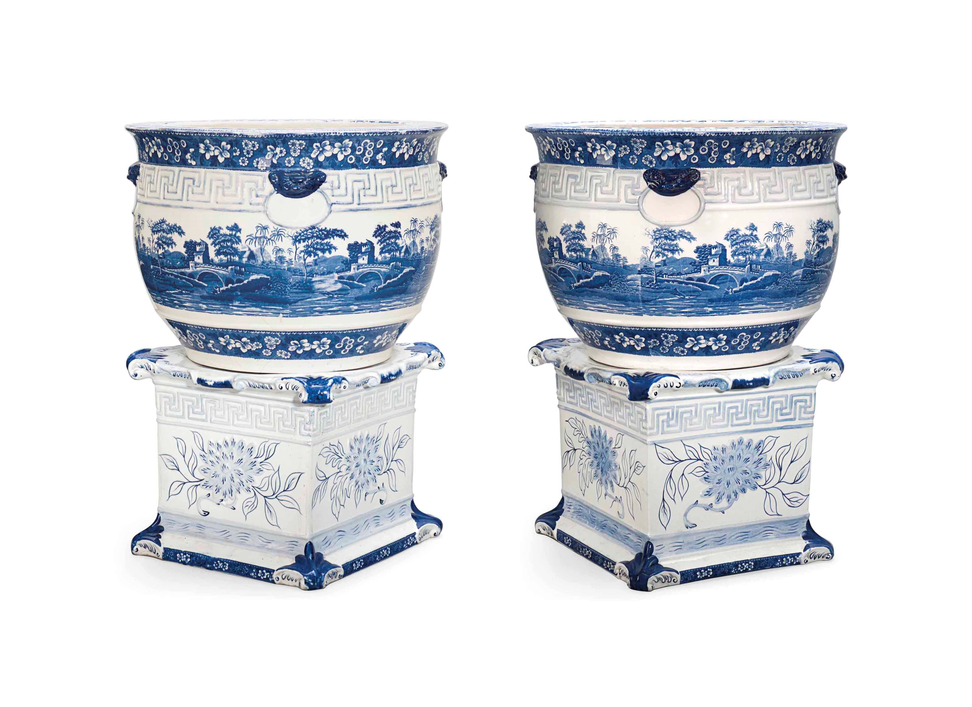 A PAIR OF COPELAND EARTHENWARE BLUE AND WHITE JARDINIERES ON PEDESTAL BASES