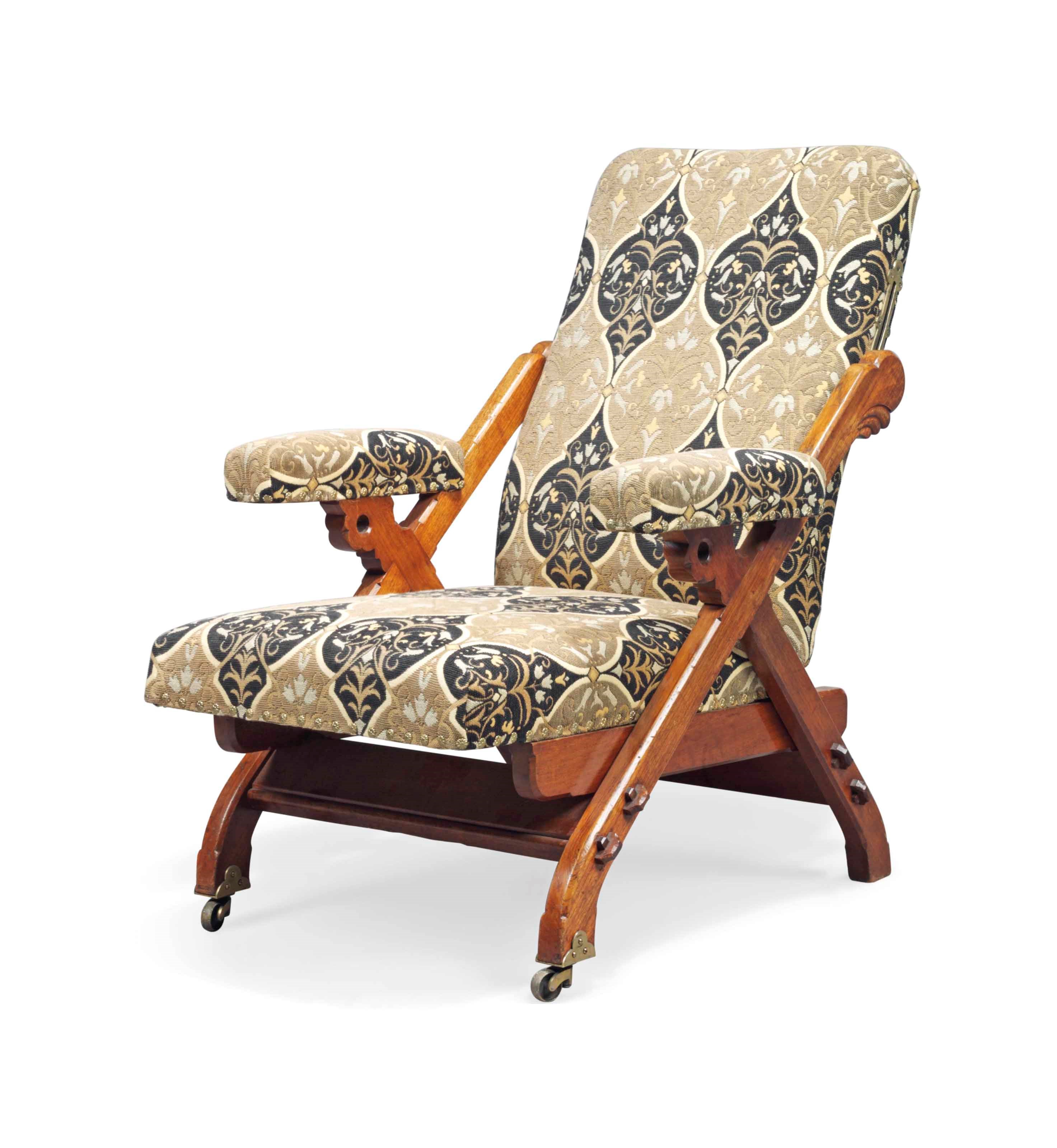 A CHARLES BEVAN (FL.1865-1882) WALNUT AND UPHOLSTERED RECLINING ARMCHAIR