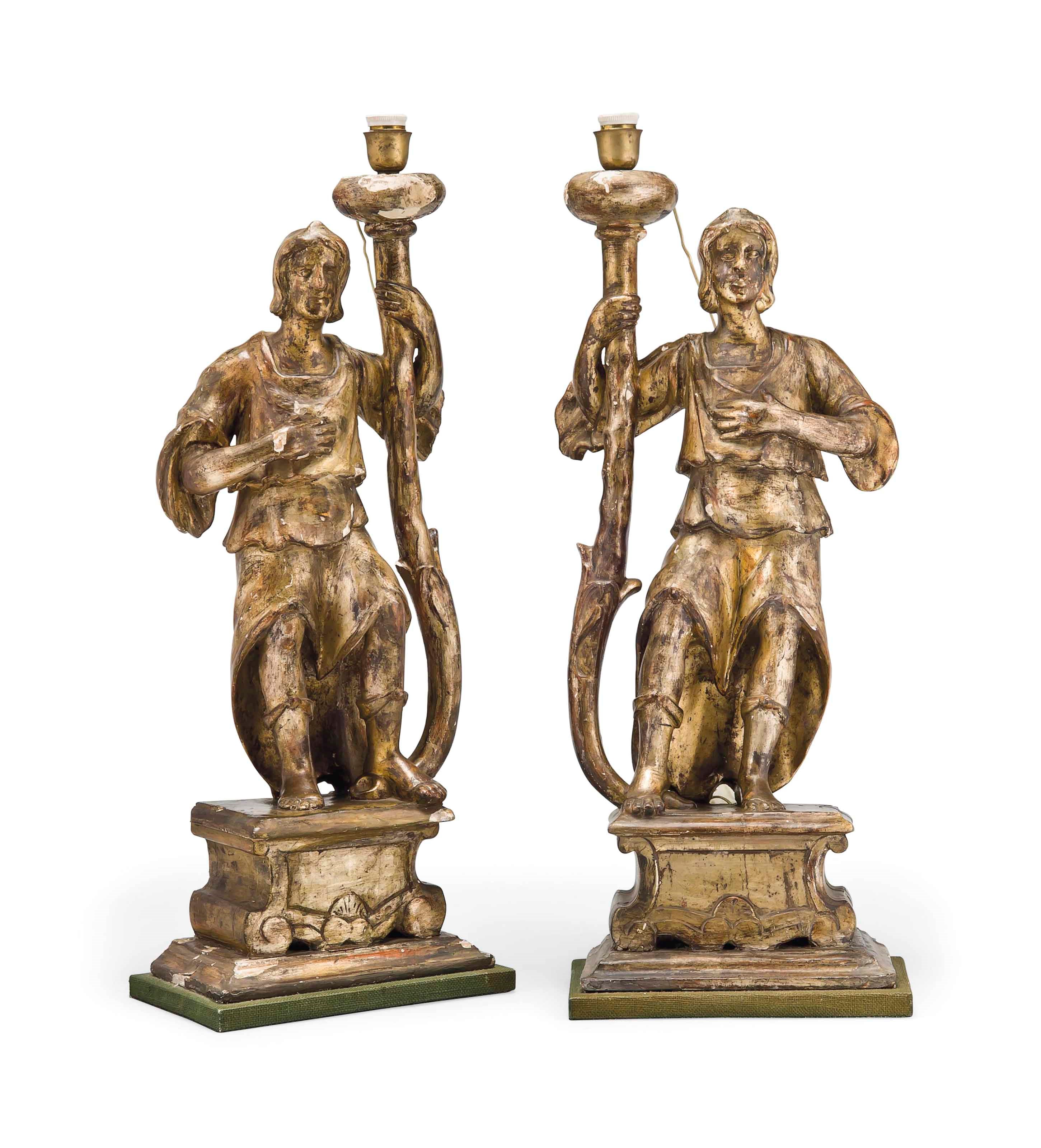 A PAIR OF ITALIAN CARVED AND SILVERED WOOD ALTARSTICKS