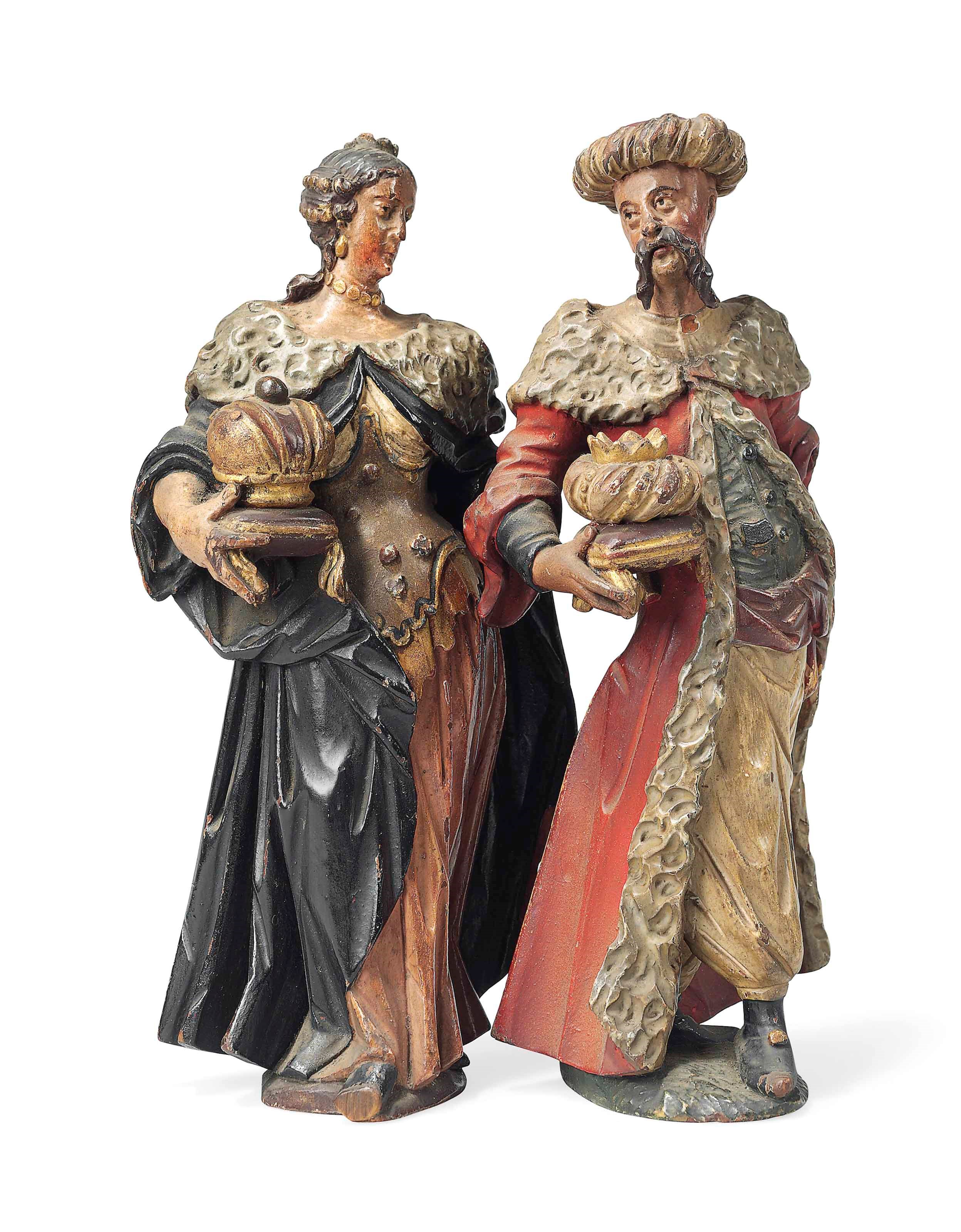 A PAIR OF PARCEL-GILT POLYCHROME CARVED WOOD FIGURES OF A MAN AND A WOMAN
