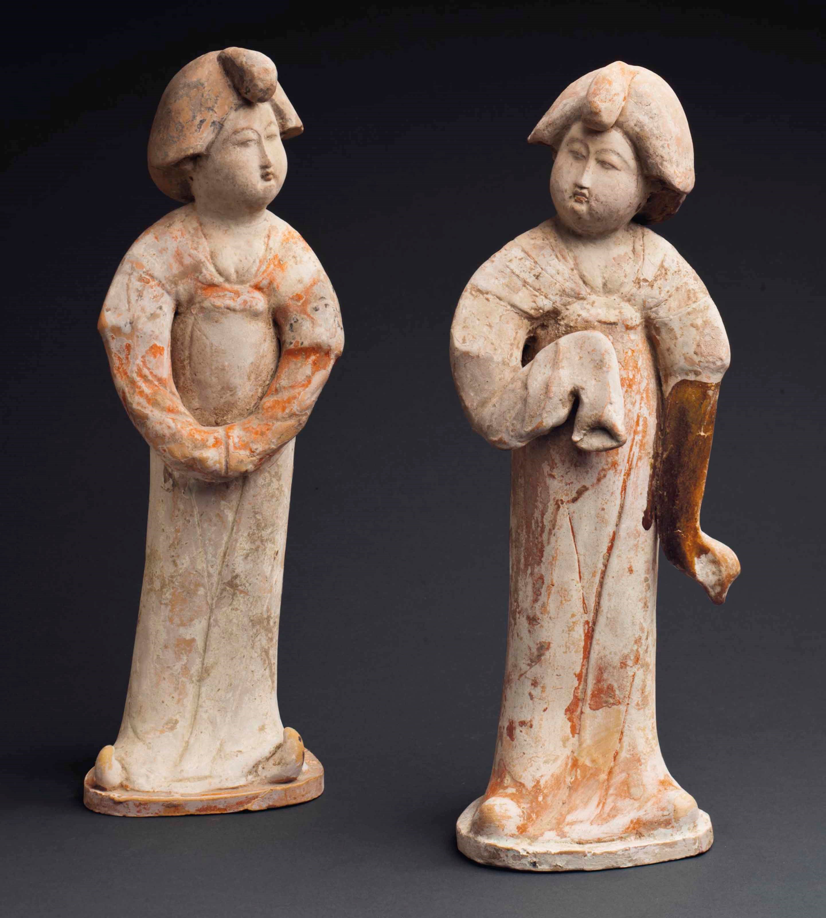 A PAIR OF PAINTED RED POTTERY FIGURES OF COURT LADIES