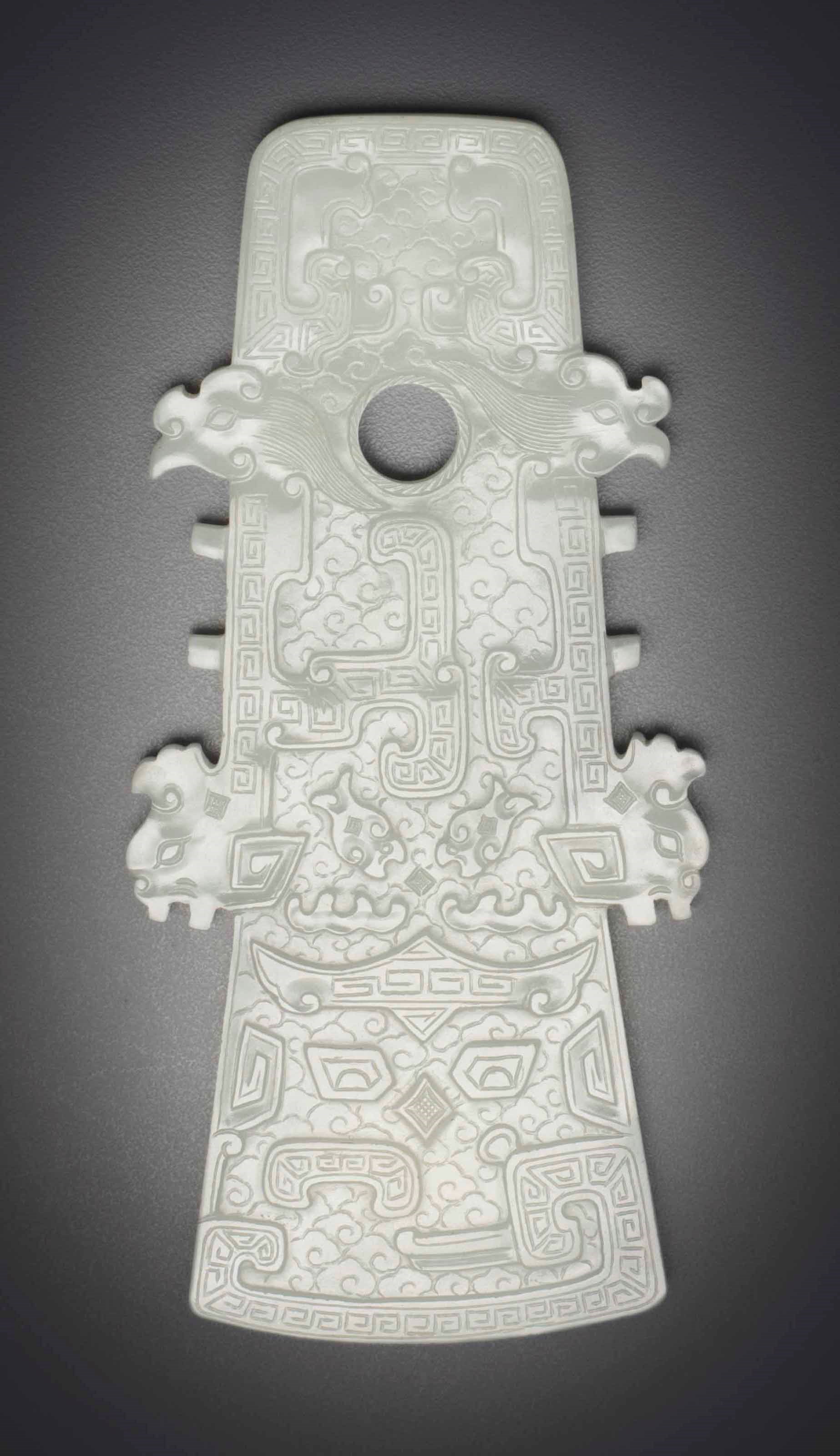 A WHITE JADE ARCHAISTIC AXE-FORM PLAQUE