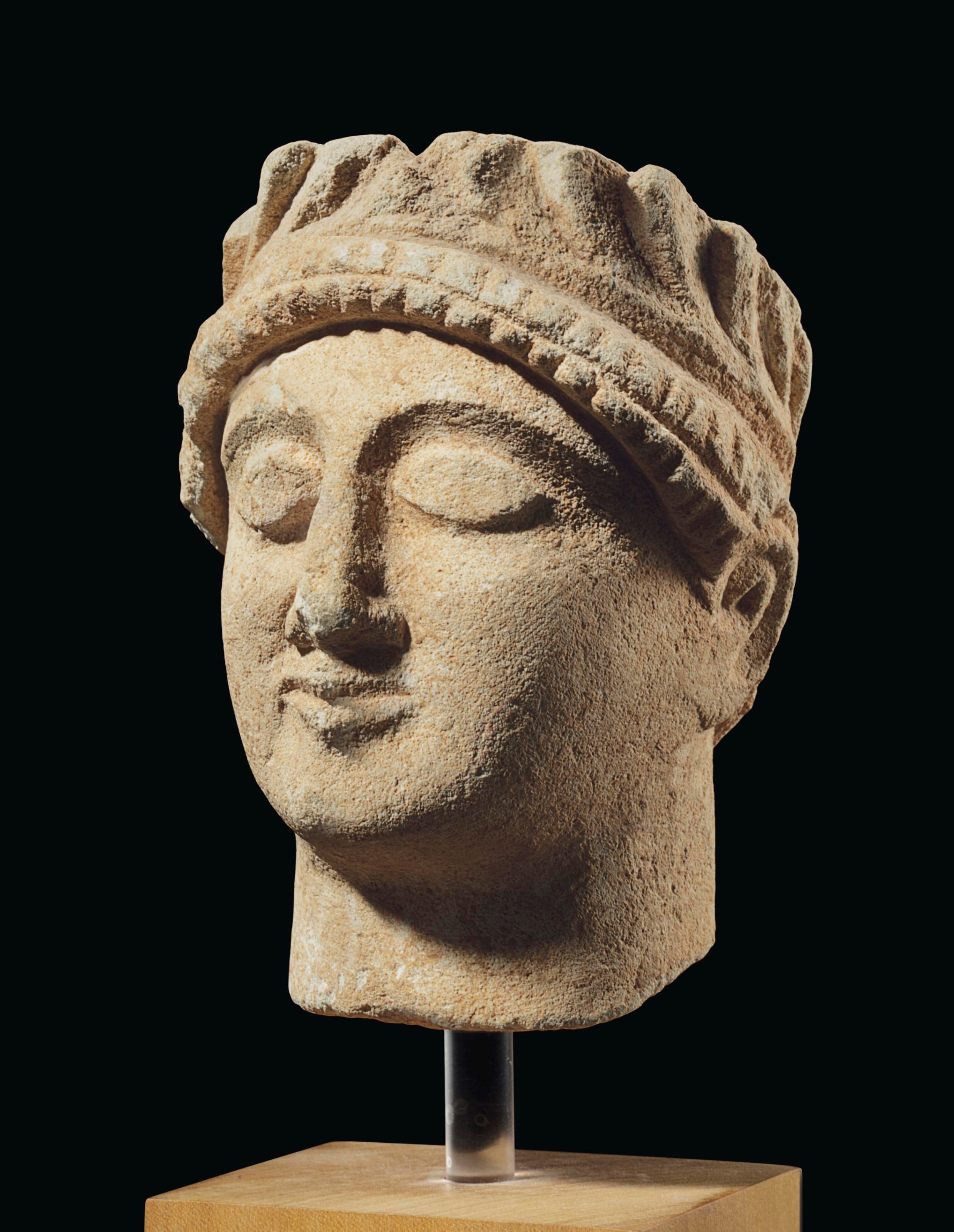 A CYPRIOT LIMESTONE HEAD OF A YOUTH
