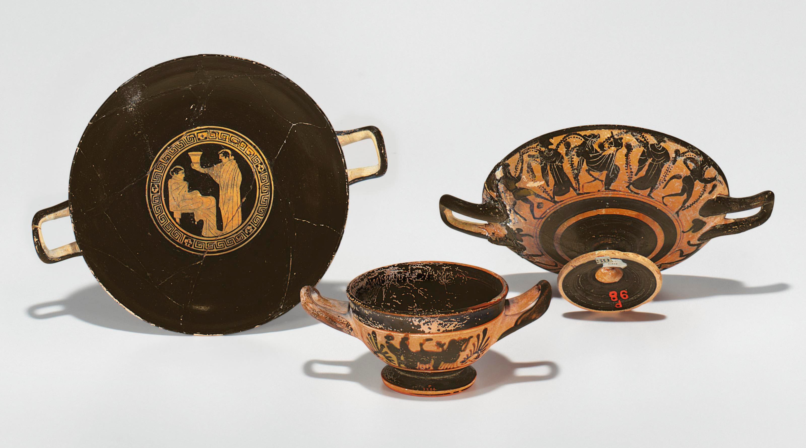 THREE ATTIC POTTERY CUPS