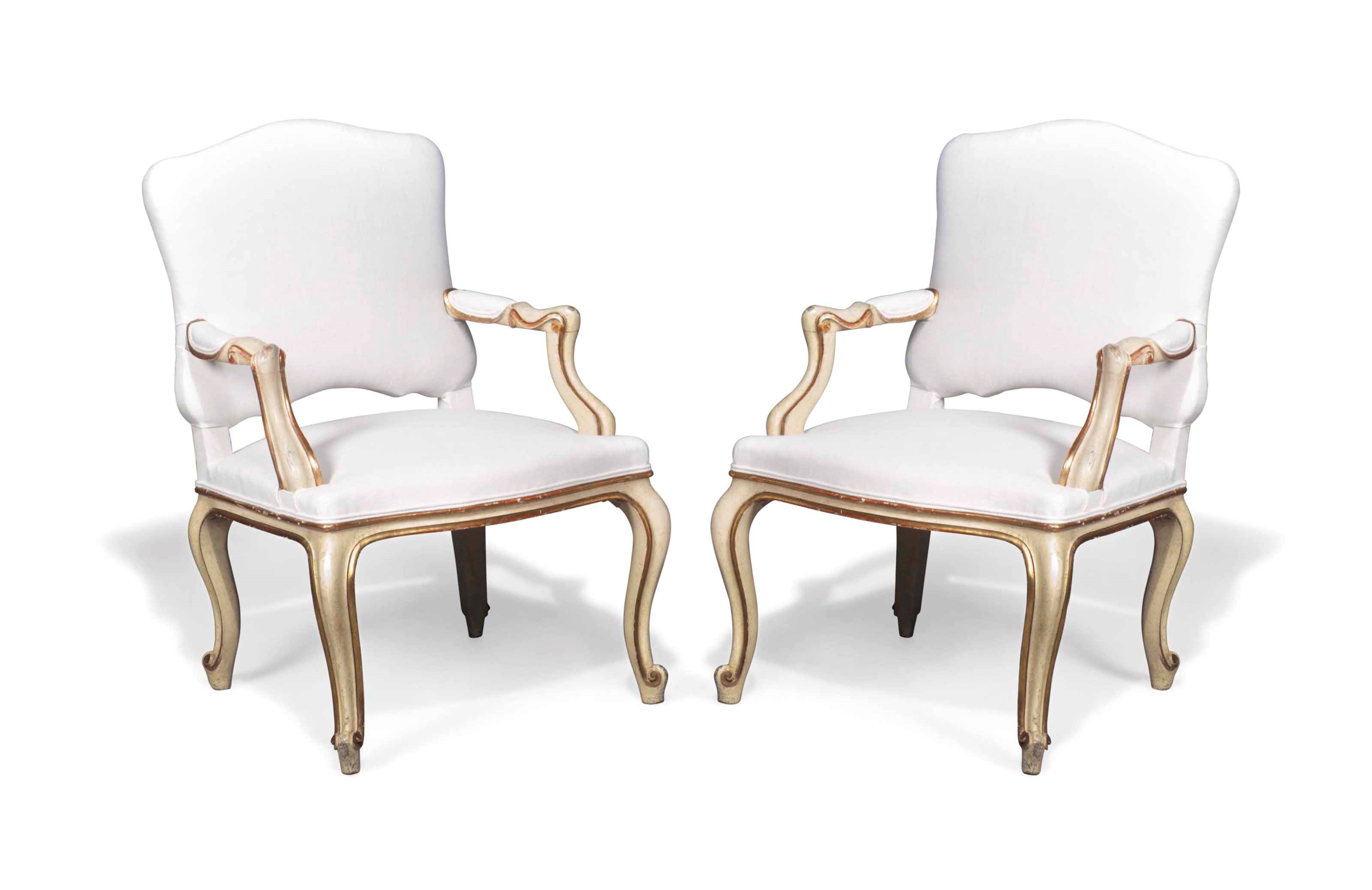A PAIR OF ITALIAN CREAM-PAINTED AND PARCEL-GILT FAUTEILS