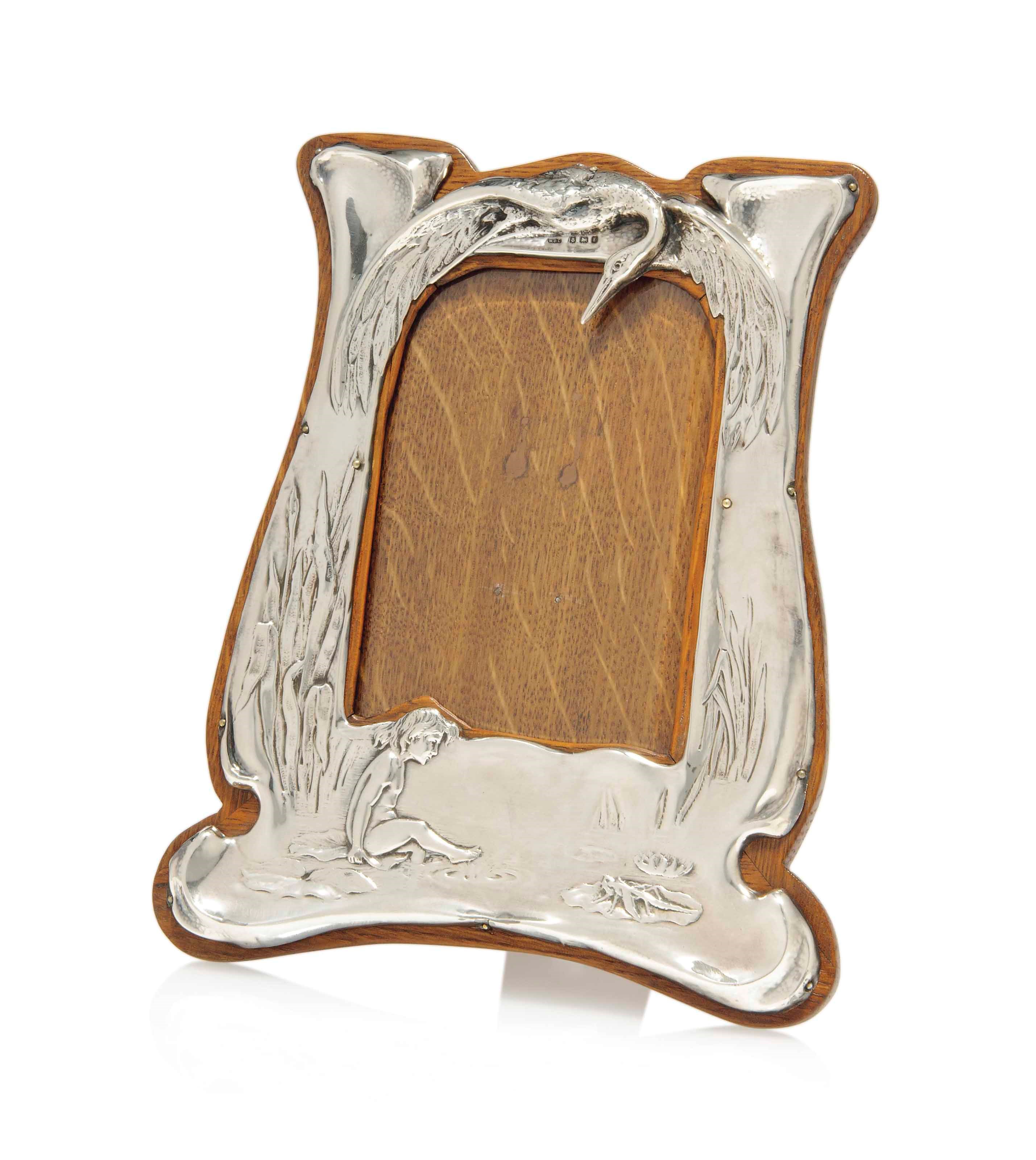 A SILVER AND OAK PHOTOGRAPH FRAME