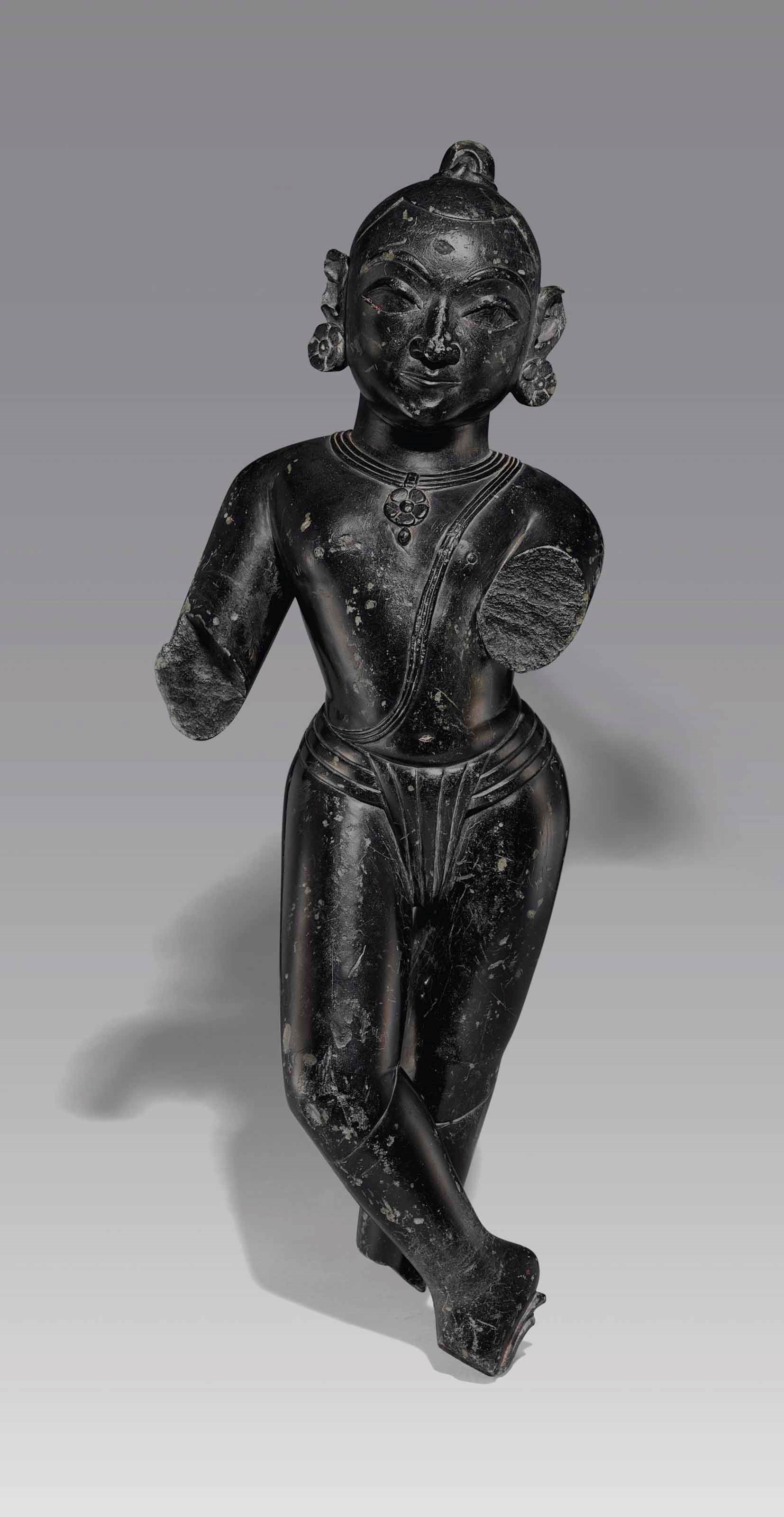 A black marble figure of Krishna Venugopala