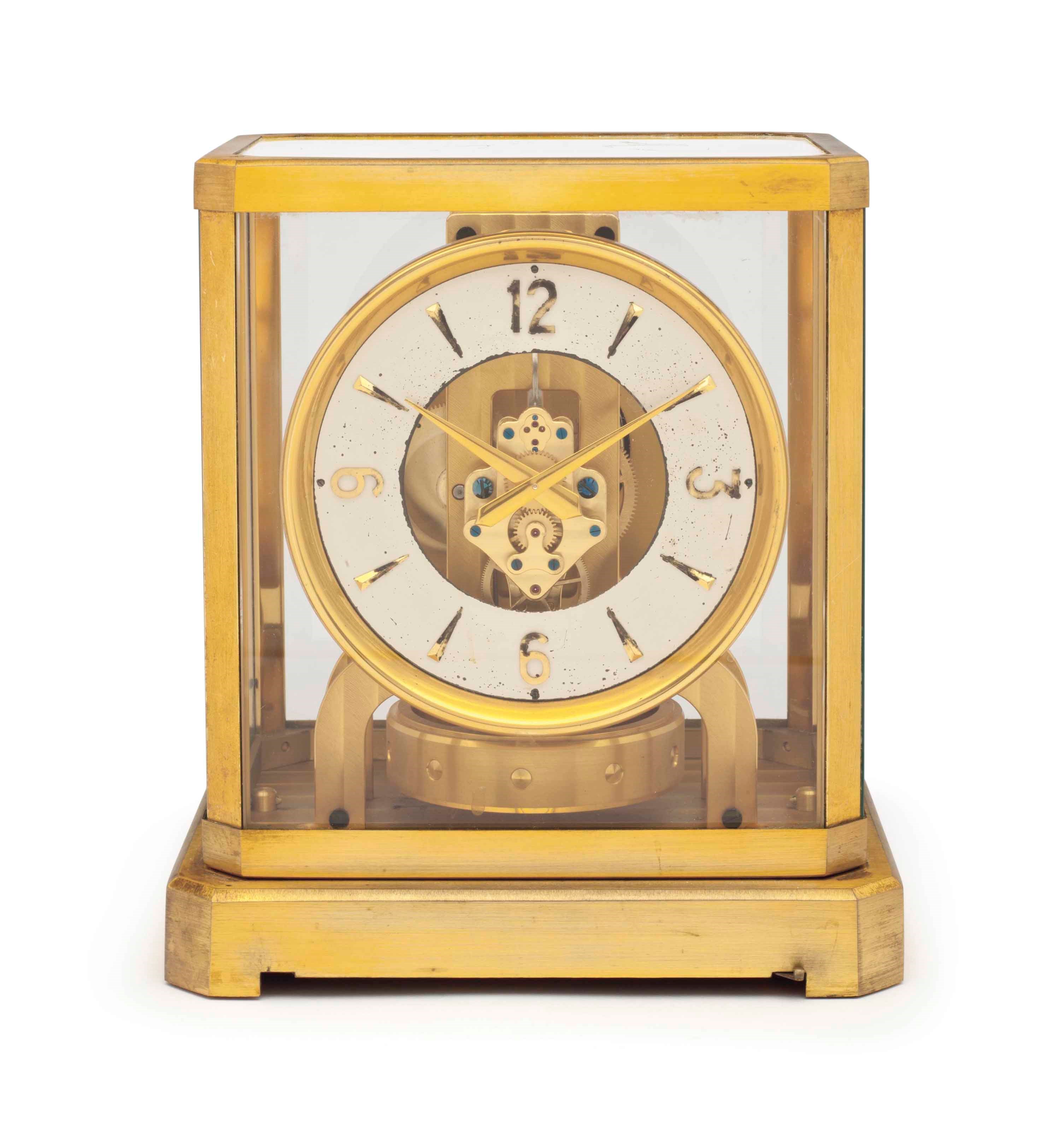 Jaeger-LeCoultre. An Early Gilt Brass and Glass Atmos Clock with Pamphlet