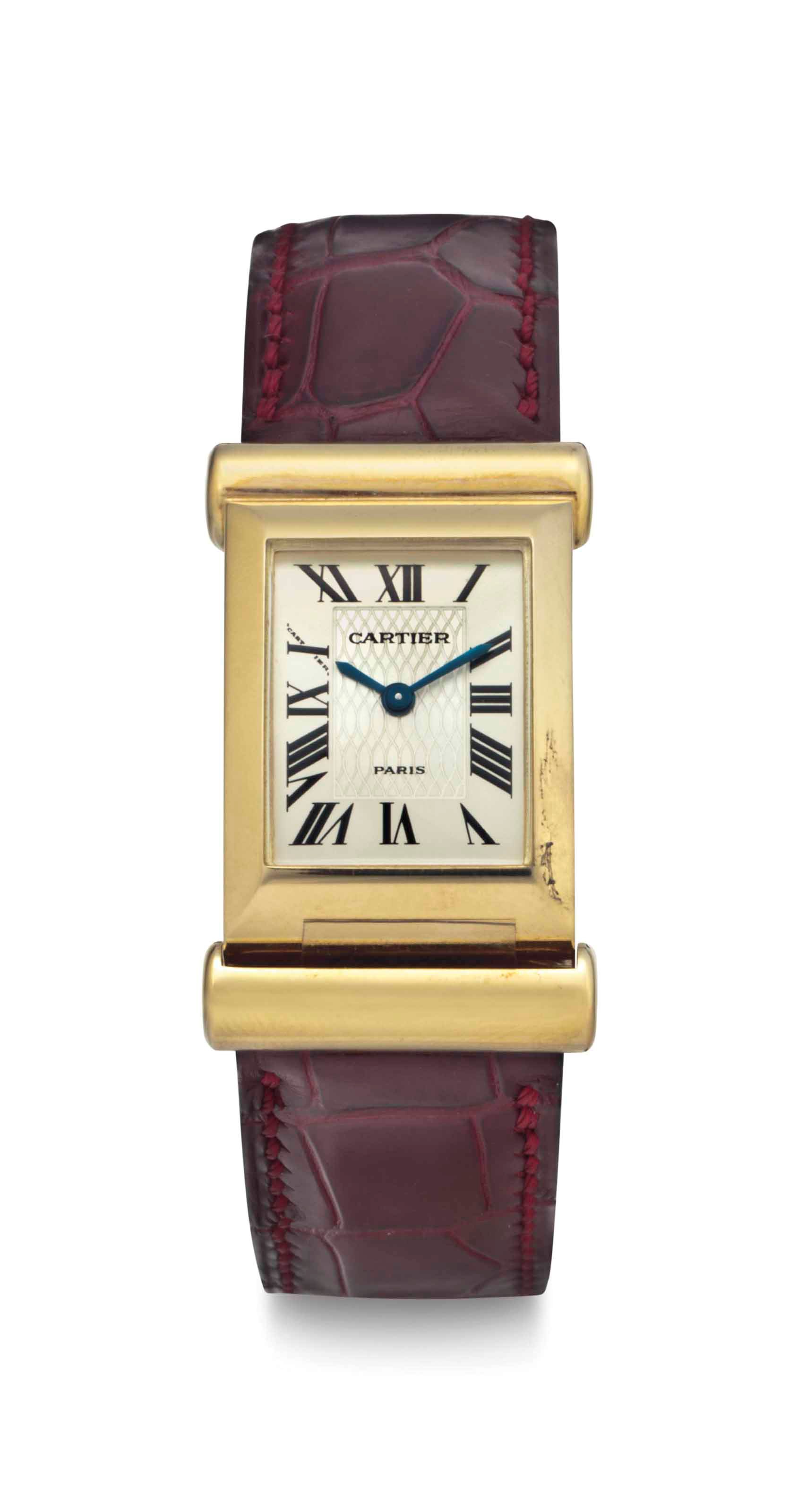 Cartier. A Limited Edition Lady's 18k Gold Rectangular Curved Back Wind Wristwatch