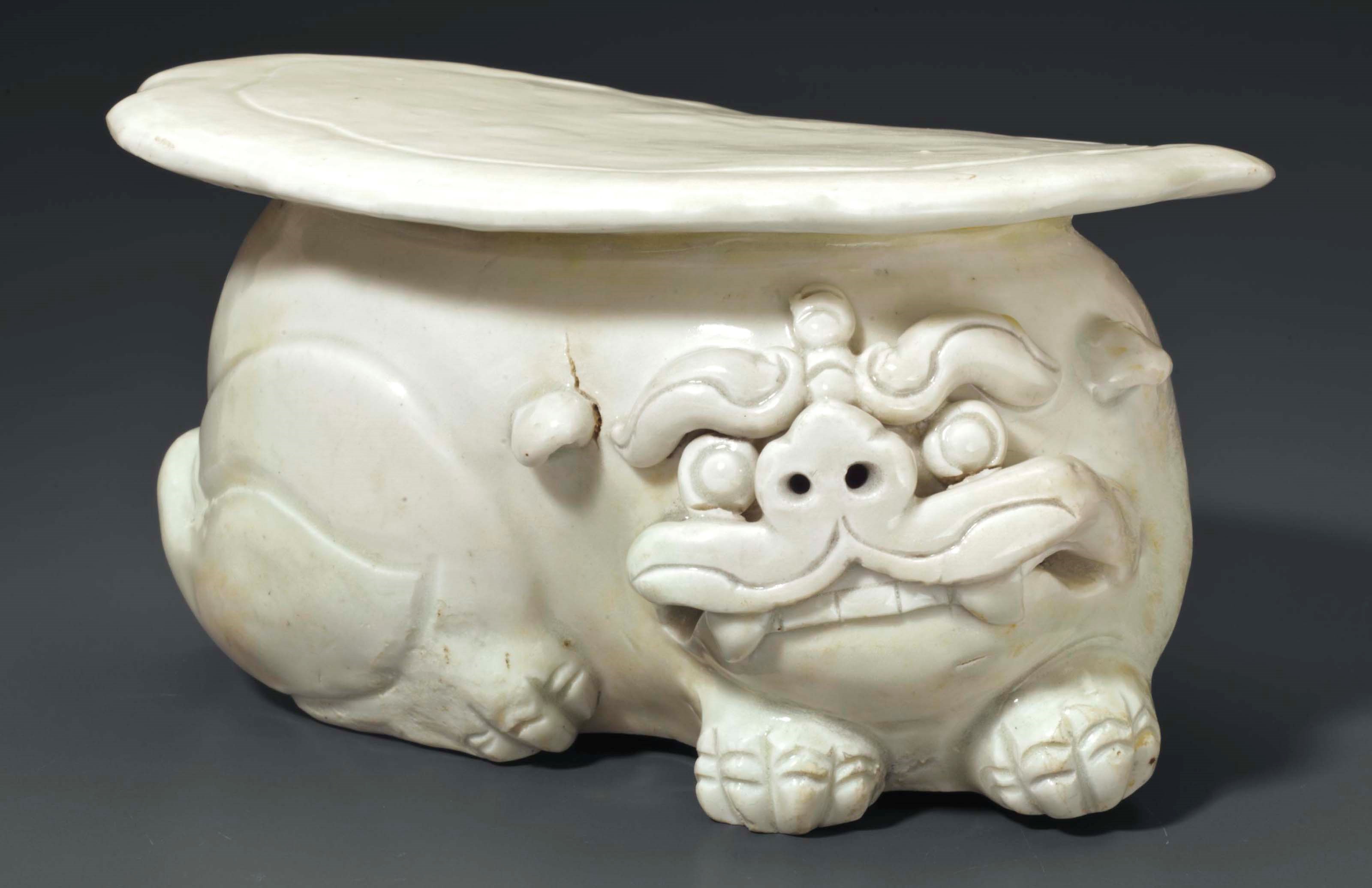 A NORTHERN WHITE WARE FIGURAL PILLOW