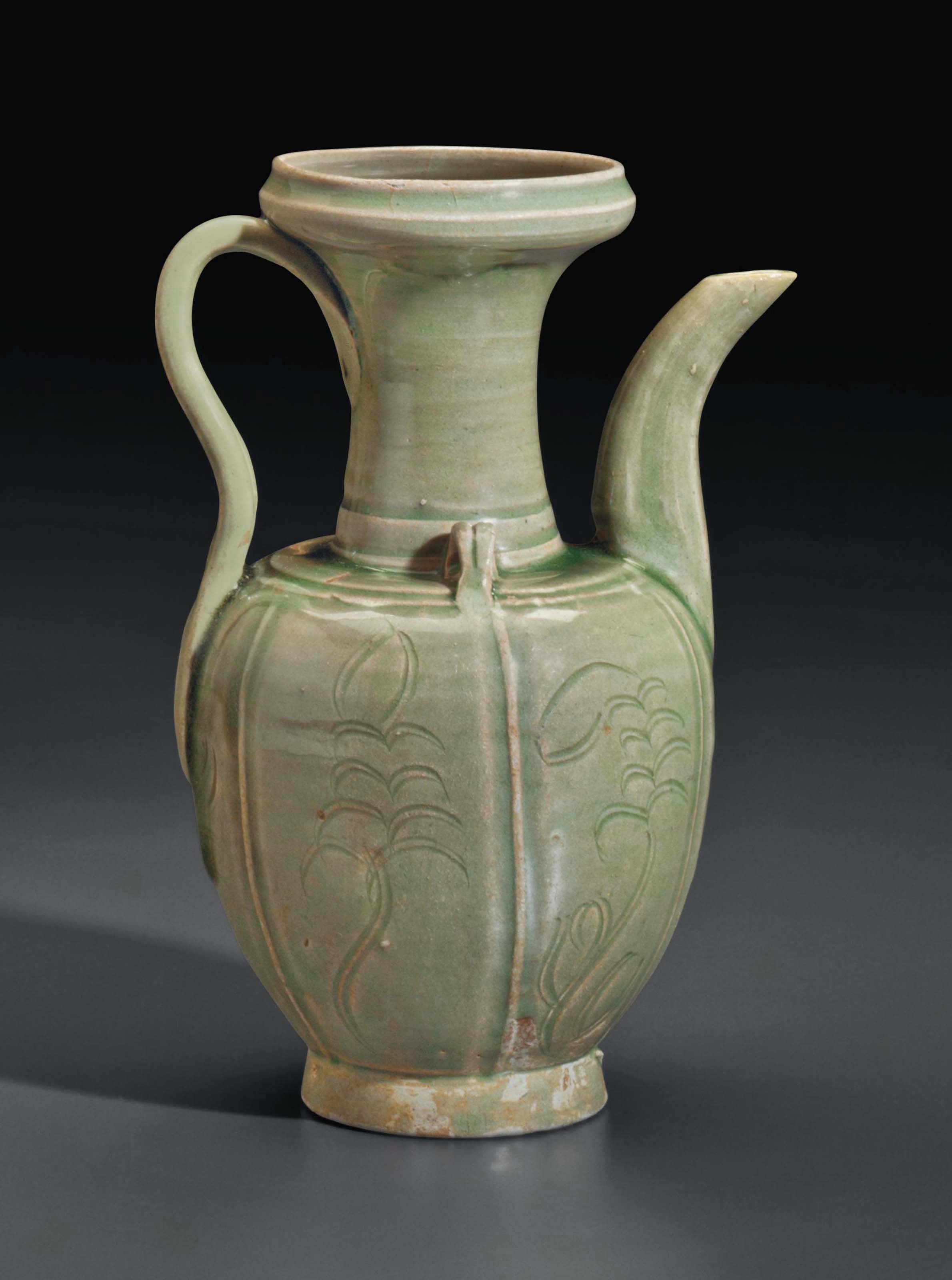 A YUE-TYPE CELADON CARVED EWER