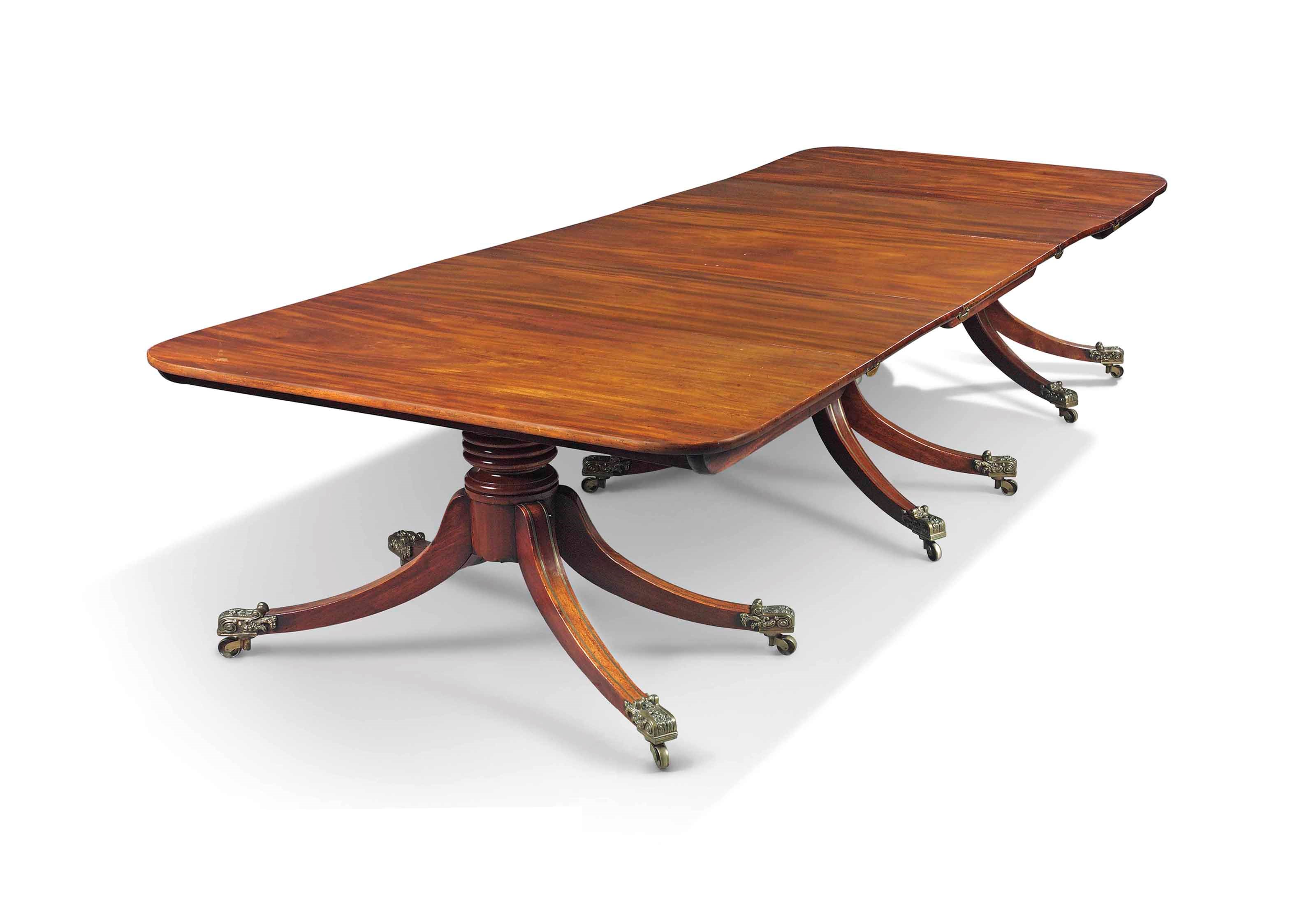 A WILLIAM IV MAHOGANY AND BRASS-INLAID TRIPLE PEDESTAL DINING-TABLE