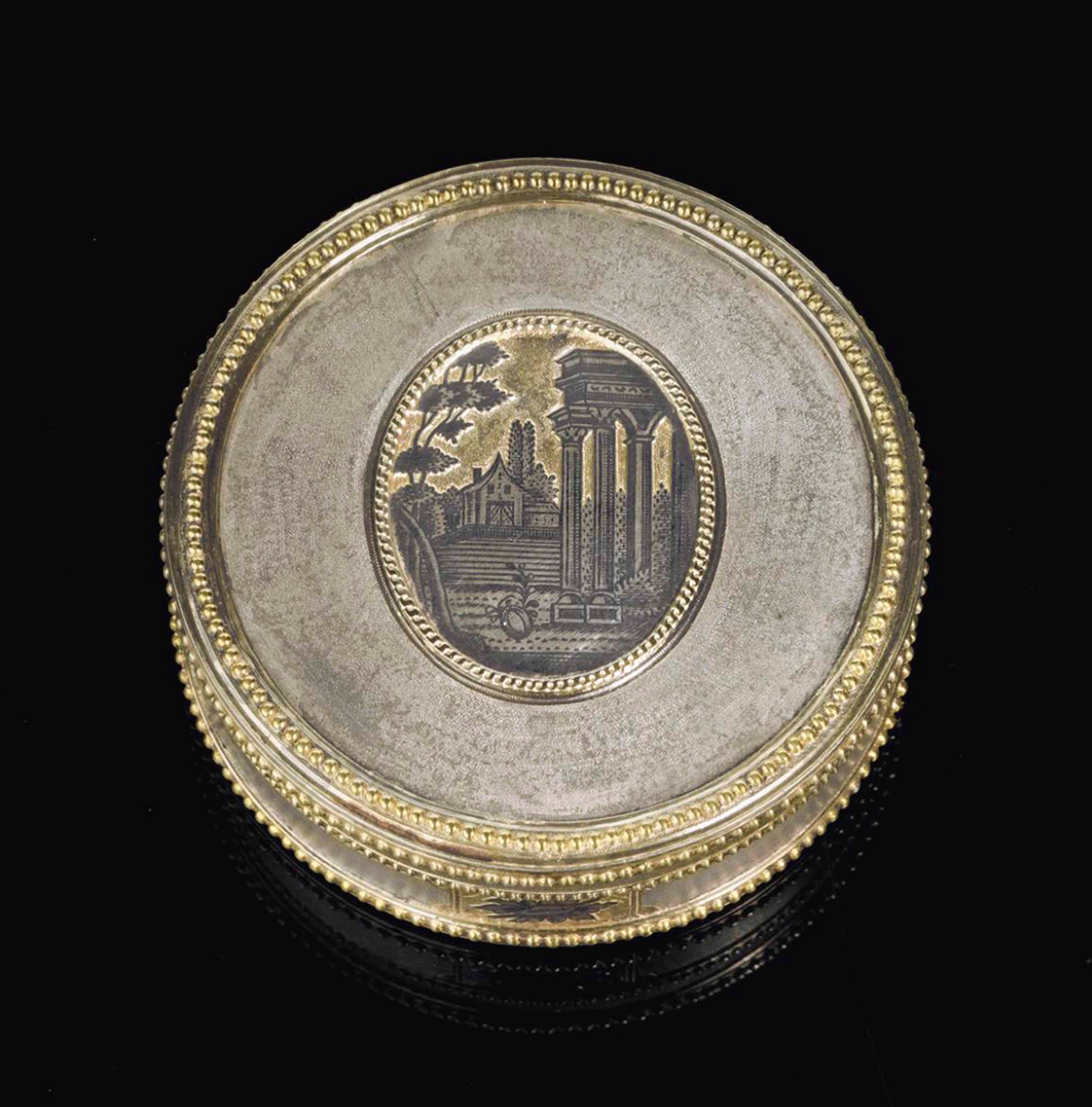 A PARCEL-GILT SILVER AND NIELLO CIRCULAR BOX