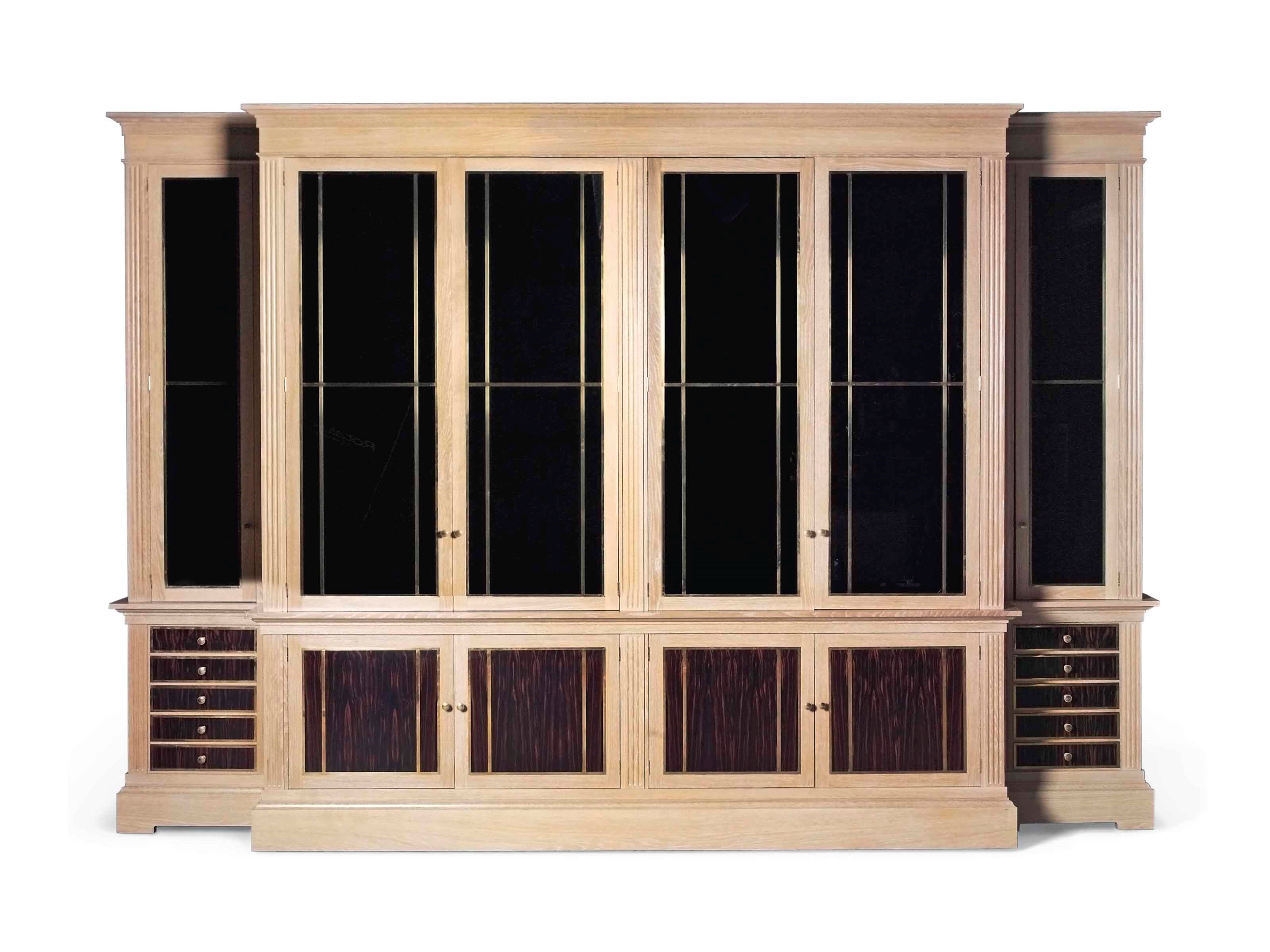 A LARGE GILT-BRASS MOUNTED, LIMED OAK AND CALAMANDER BREAKFRONT LIBRARY BOOKCASE OR CABINET