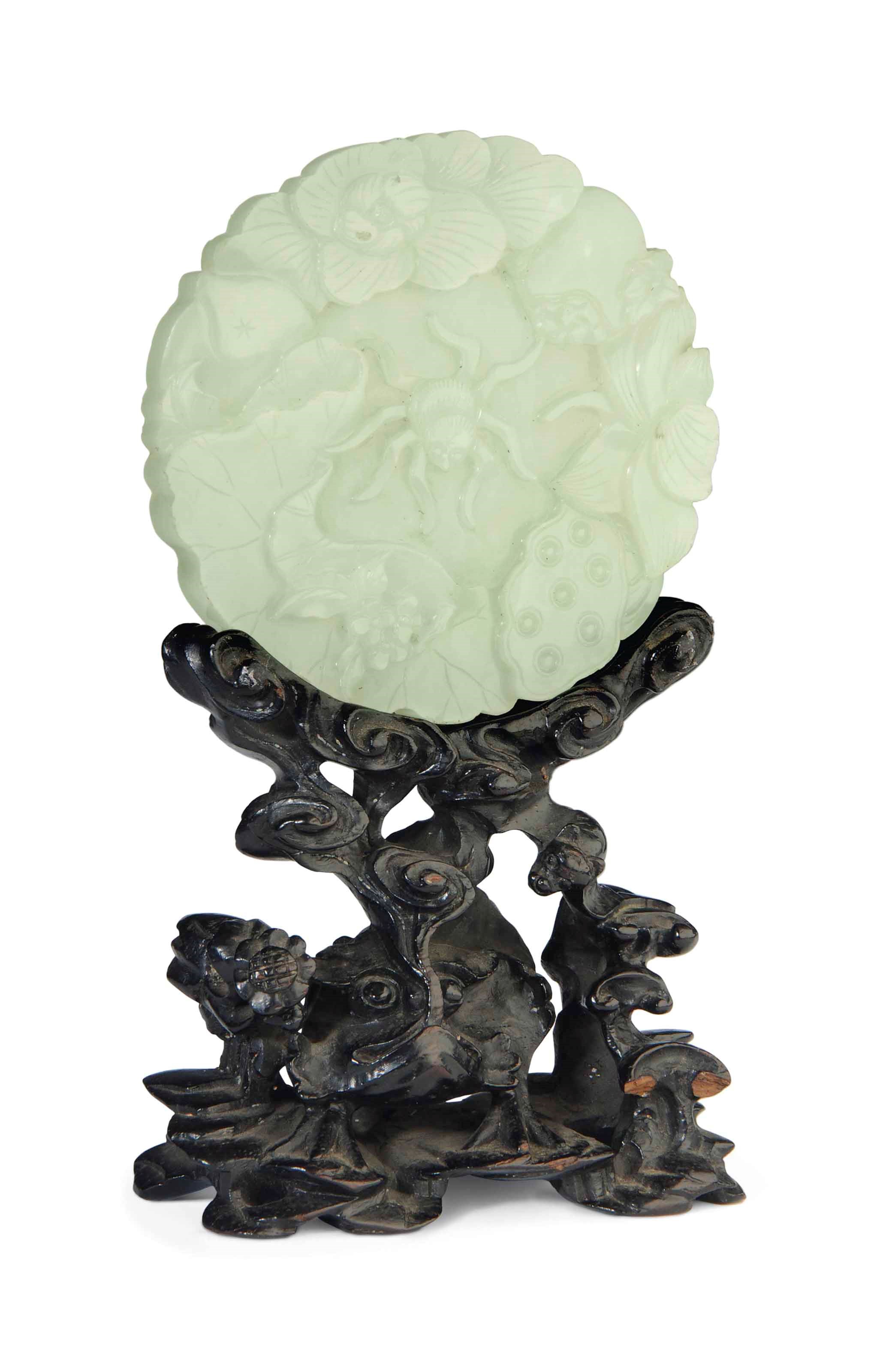 A CIRCULAR WHITE JADE 'LOTUS AND SPIDER' PLAQUE