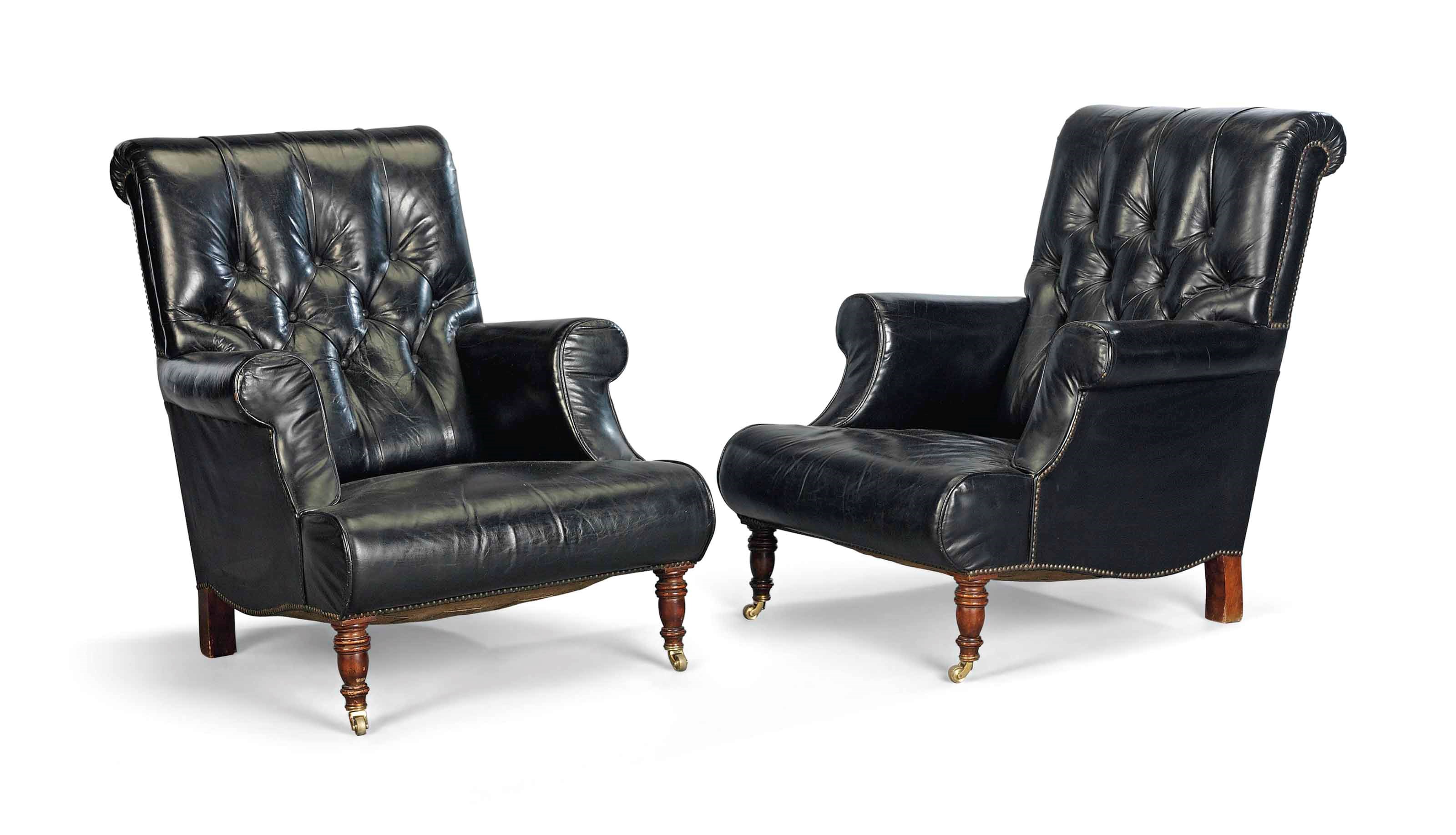 A PAIR OF BLACK LEATHER EASY ARMCHAIRS