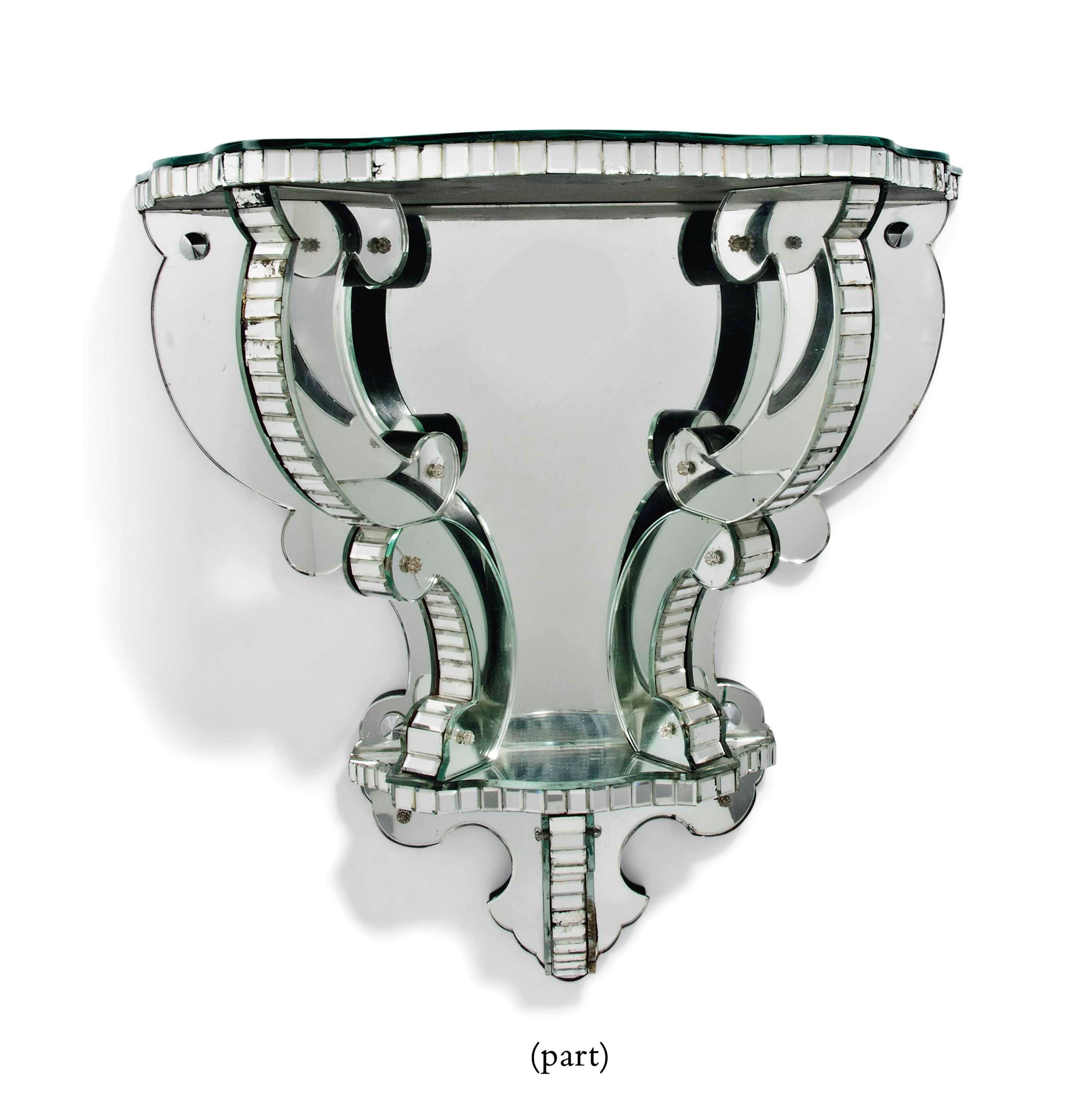 A PAIR OF MIRRORED GLASS WALL BRACKETS