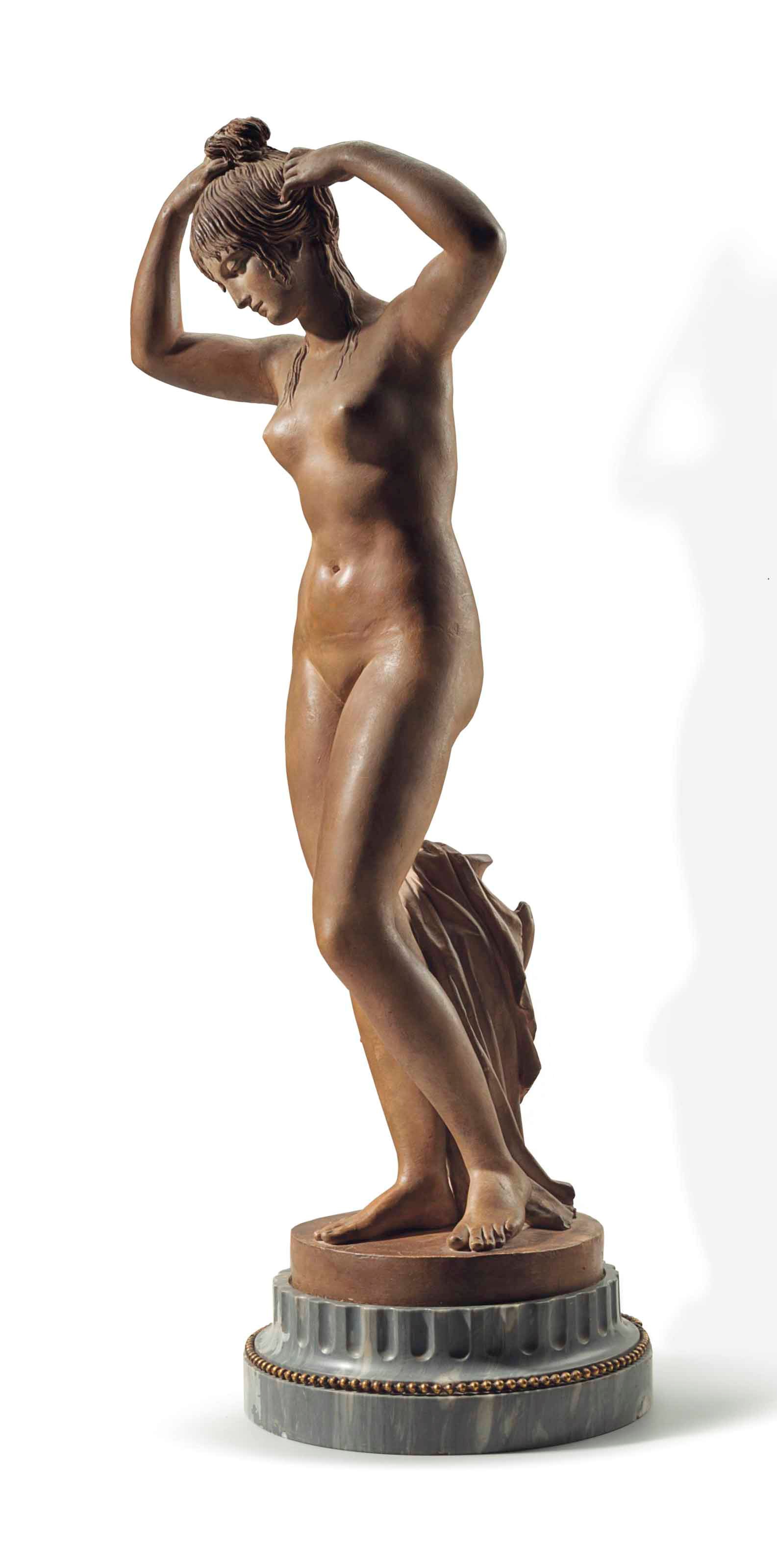 A TERRACOTTA FIGURE OF A BATHER