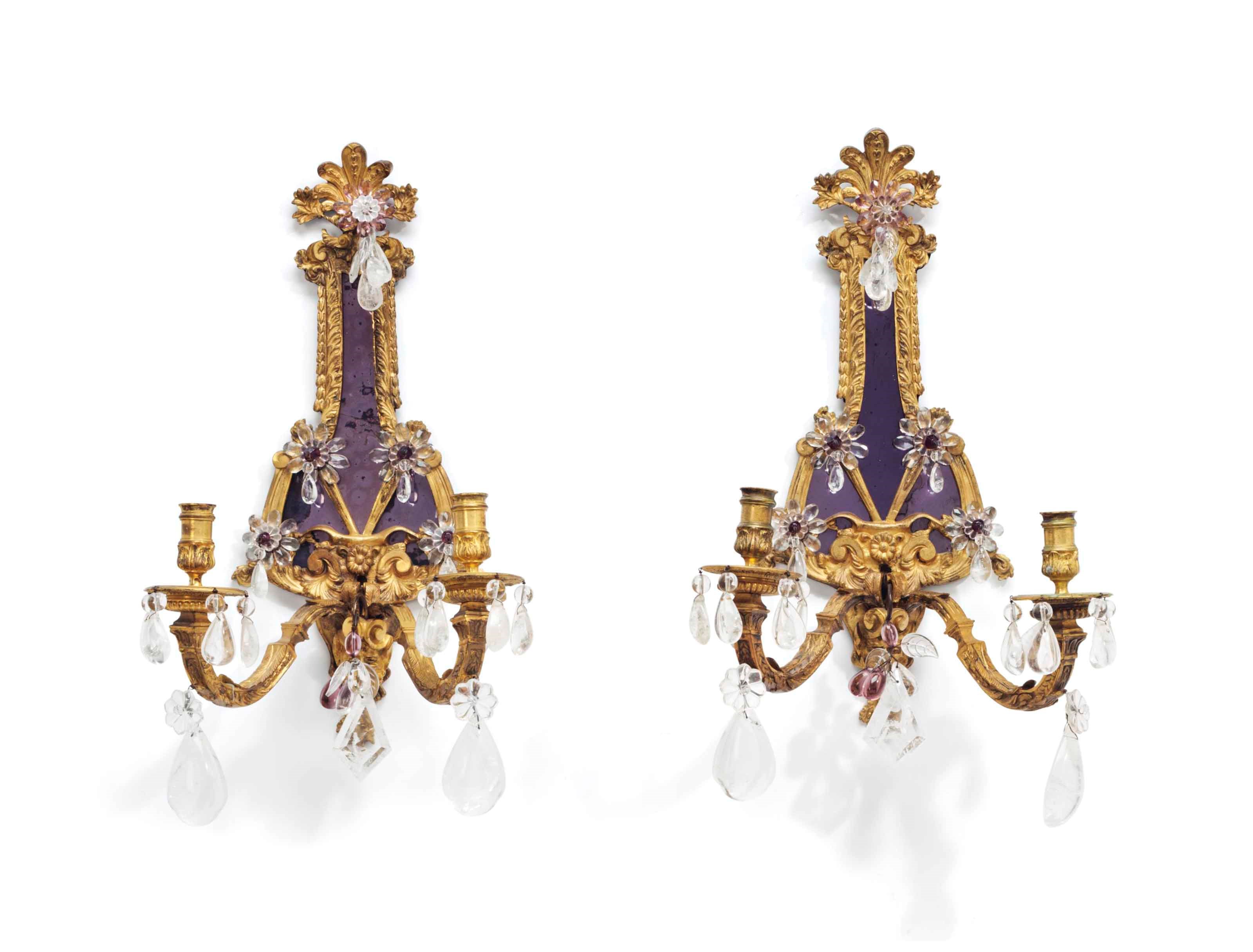 A PAIR OF REGENCE STYLE GILT-METAL ROCK CRYSTAL AND PRESSED-GLASS TWO-LIGHT WALL SCONCES