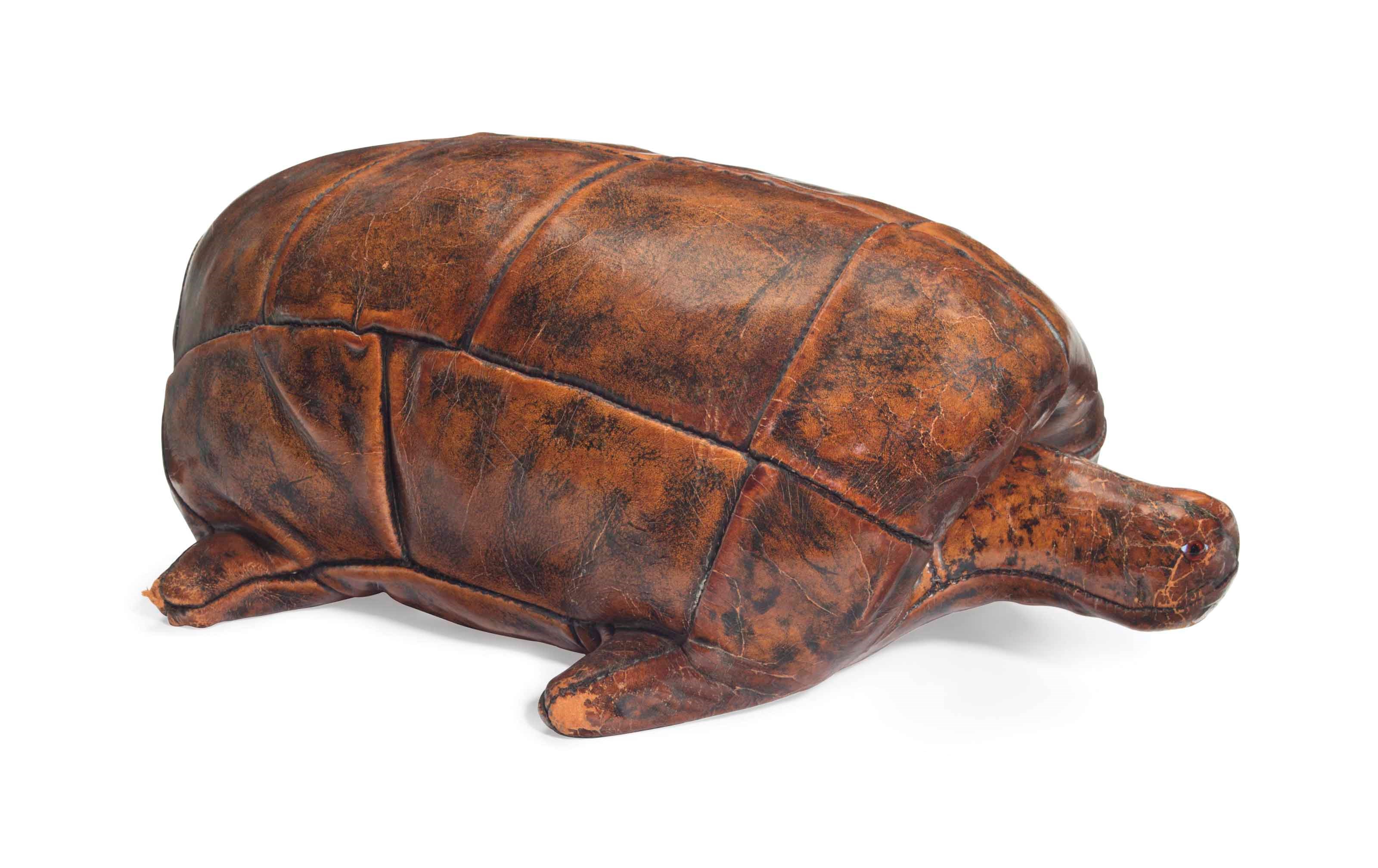 AN ENGLISH COWHIDE LEATHER TURTLE-FORM OTTOMAN