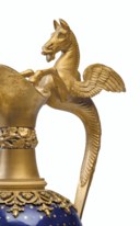 A PAIR OF EMPIRE ORMOLU AND ENAMEL EWERS