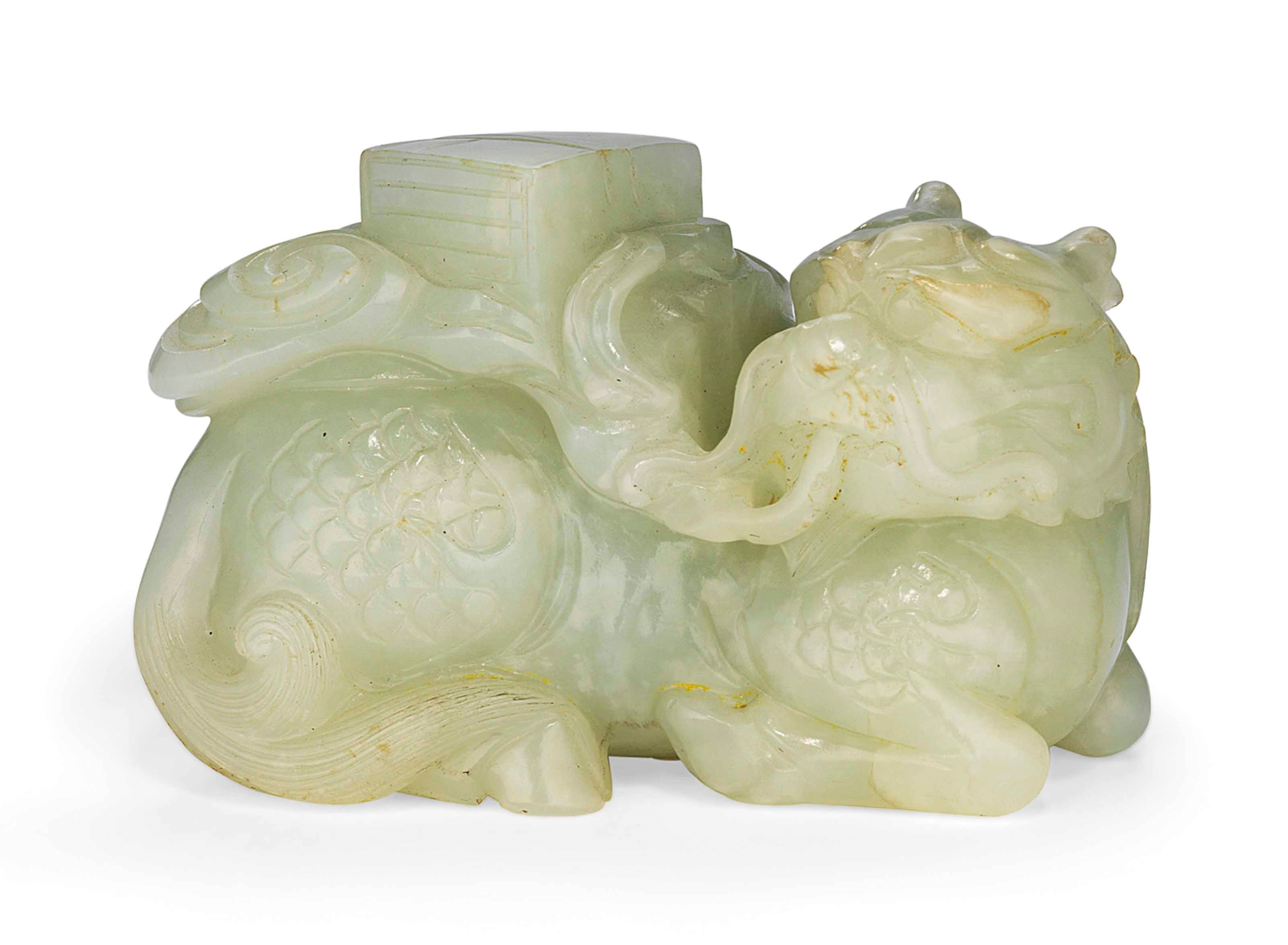 A CHINESE CELADON JADE CARVING OF A QILIN