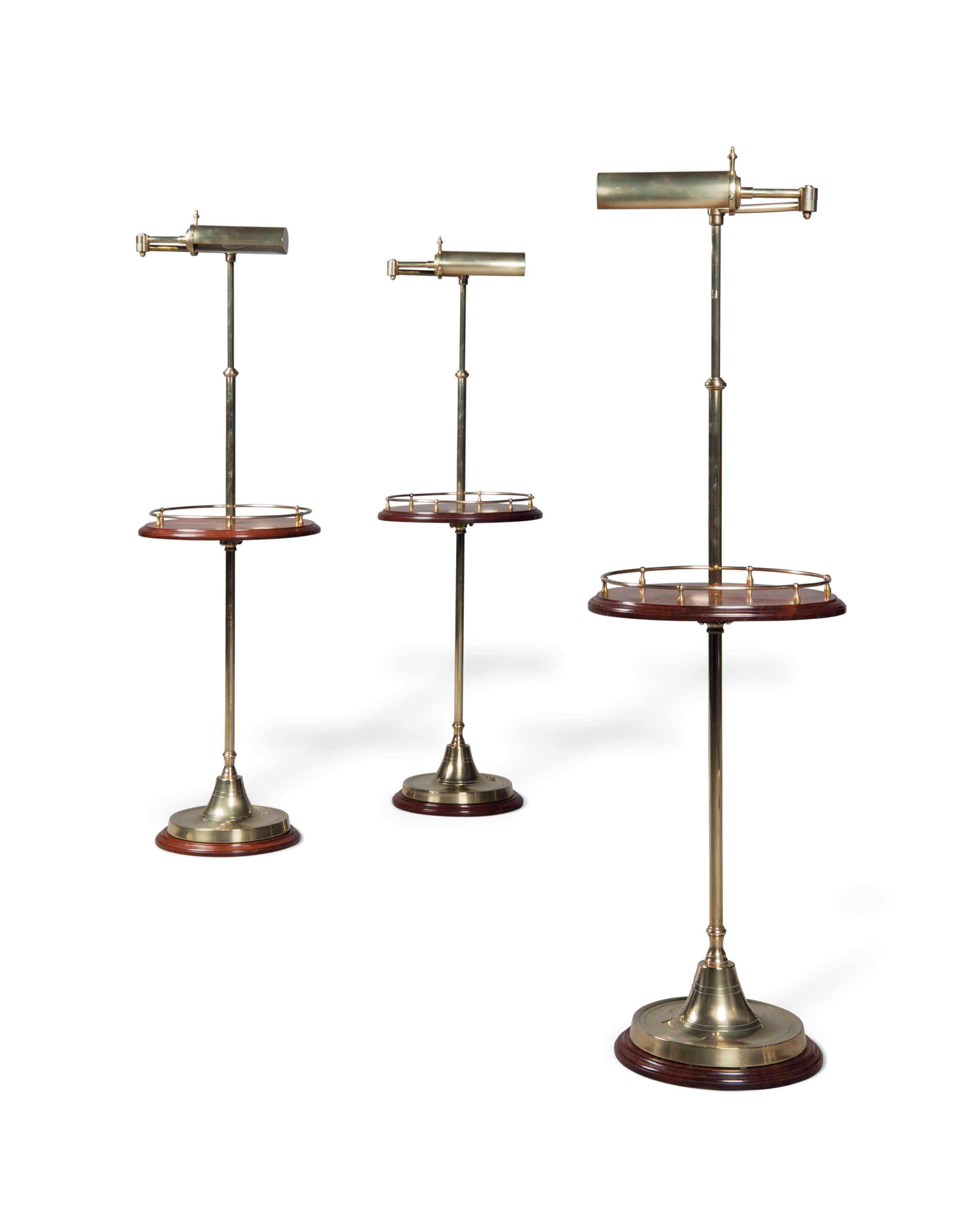 A SET OF THREE ENGLISH BRASS AND MAHOGANY ADJUSTABLE READING LAMPS