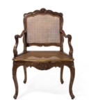 A FRENCH BEECHWOOD AND CANED FAUTEUIL