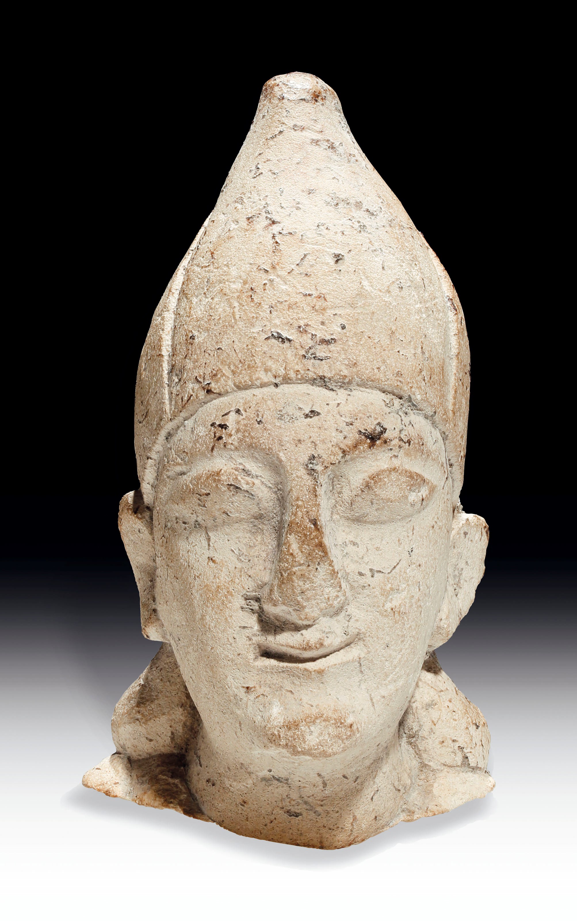 A CYPRIOT LIMESTONE HEAD OF A MALE VOTARY