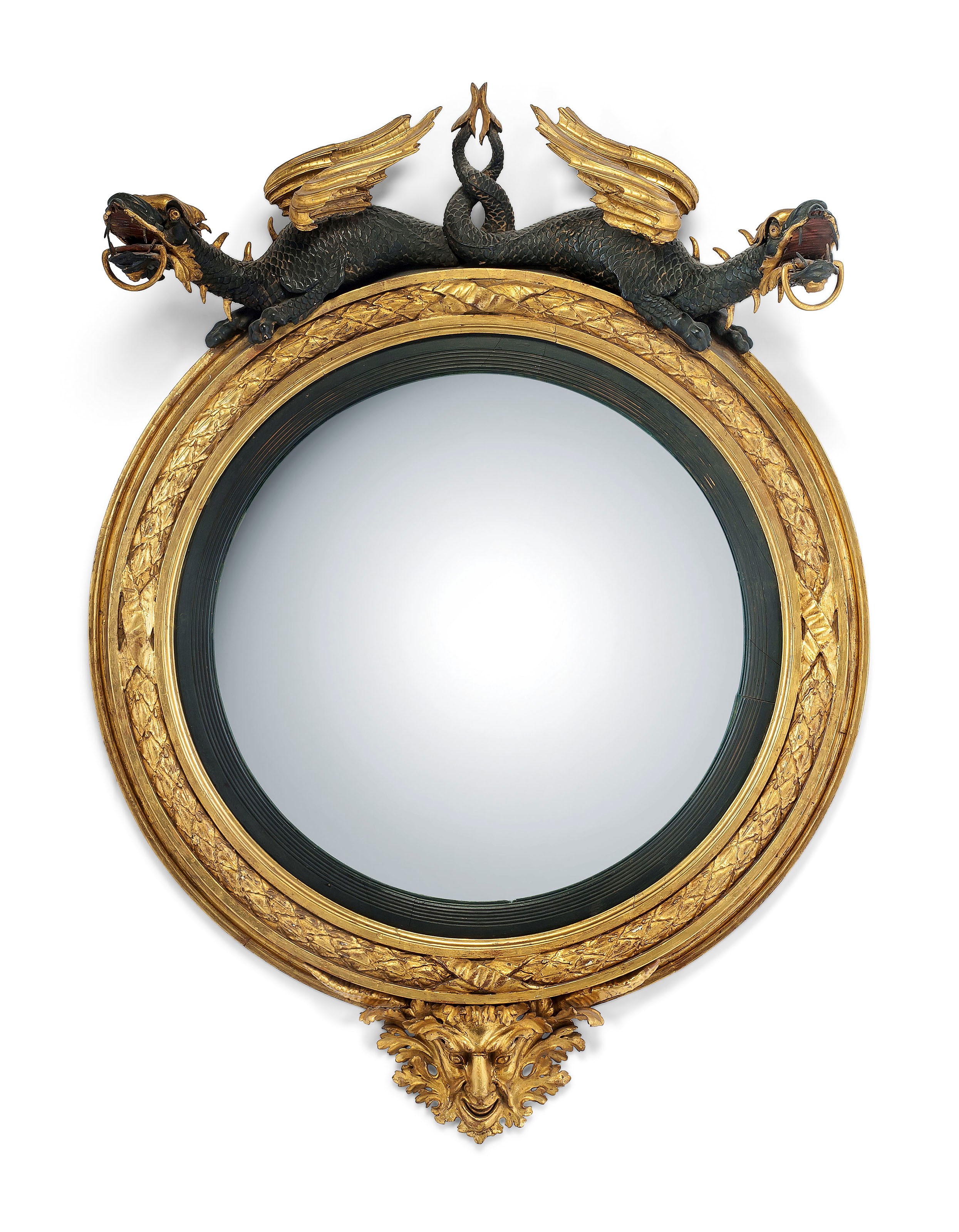 A REGENCY GILTWOOD AND EBONIZED CONVEX MIRROR