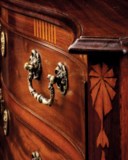 A GEORGE III MAHOGANY AND SYCAMORE-INLAID SERPENTINE CHEST