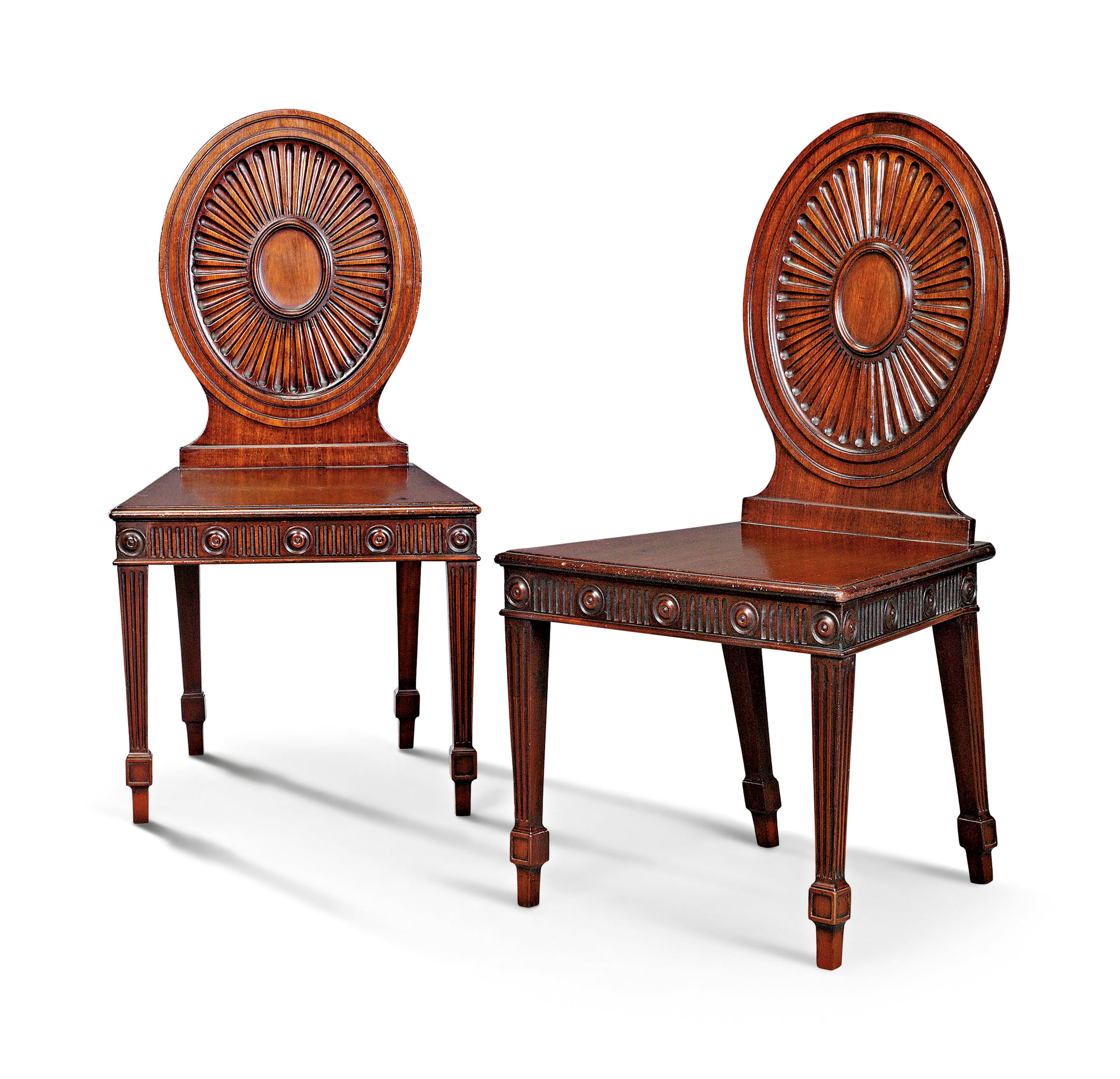 A PAIR OF GEORGE III MAHOGANY HALL CHAIRS
