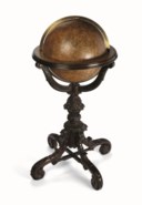 LIBRARY GLOBE – COPLEY, Charles (fl.1843-69). A 16-inch celestial globe made from two sets of twelve hand-colored engraved half gores laid to the celestial poles and two polar calottes, the constellations depicted by mythical beasts and figures and scientific instruments in yellow on a pale green ground, the stars to nine orders of magnitude with nebulae, the ecliptic given with twilight zone. Supported in graduated brass meridian ring, sitting in horizon ring with facsimile calendar supported on an extremely fine carved dark mahogany stand with three scroll and acanthus-headed quadrant supports to a stylized pineapple and carved column, outswept acanthus-carved legs with scroll feet united by cross-stretchers.
