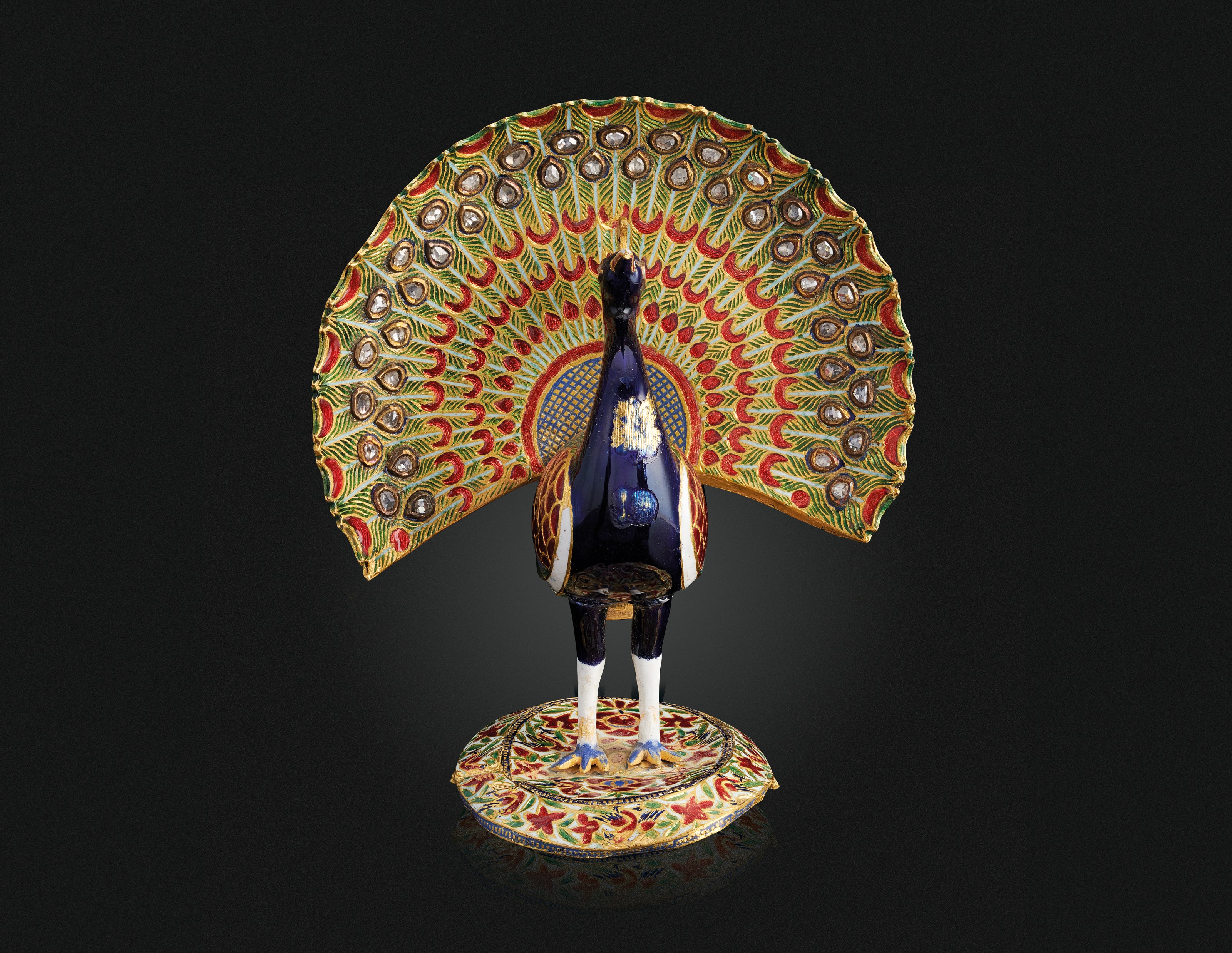 AN ENAMELLED AND DIAMOND-SET GOLD PEACOCK