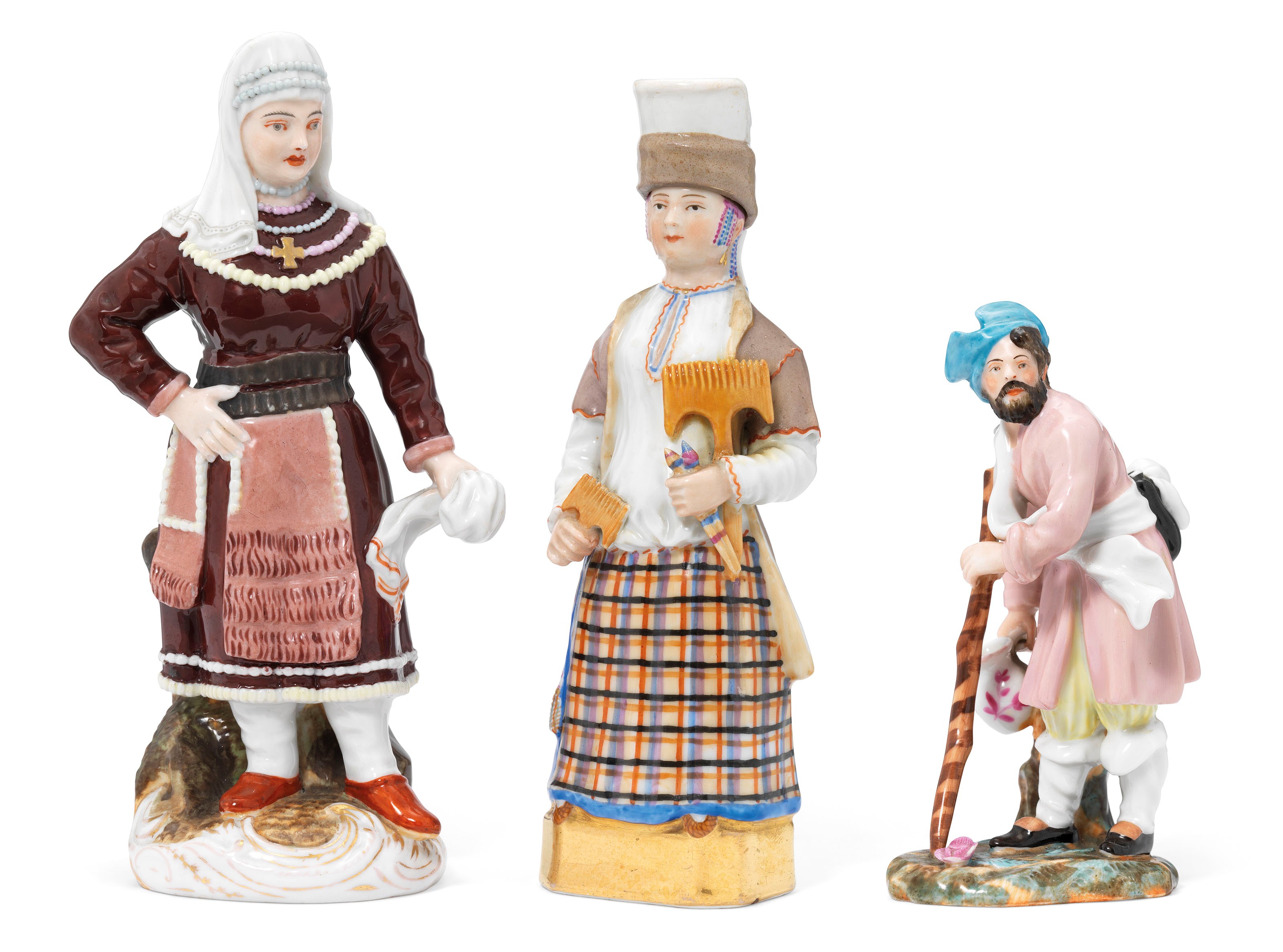 TWO PORCELAIN FIGURES OF WOMEN IN TRADITIONAL COSTUMES AND A FIGURE OF A WANDERER