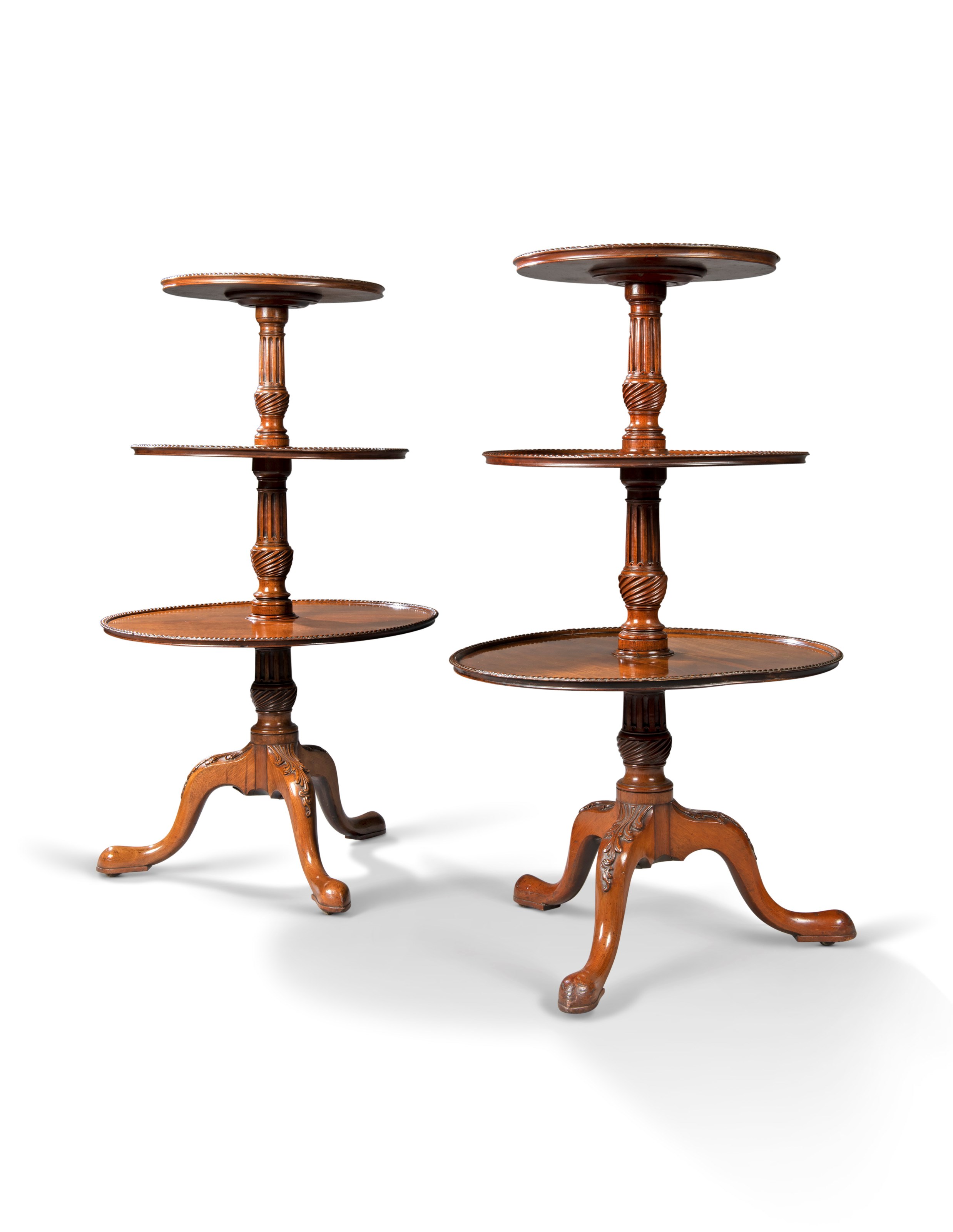 A PAIR OF GEORGE III MAHOGANY THREE-TIER DUMB WAITERS