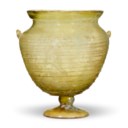 A ROMAN GREEN GLASS FOOTED KANTHAROS