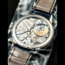 PATEK PHILIPPE. AN 18K WHITE GOLD AUTOMATIC ANNUAL CALENDAR WRISTWATCH WITH REGULATOR-STYLE DIAL, SINGLE SEALED