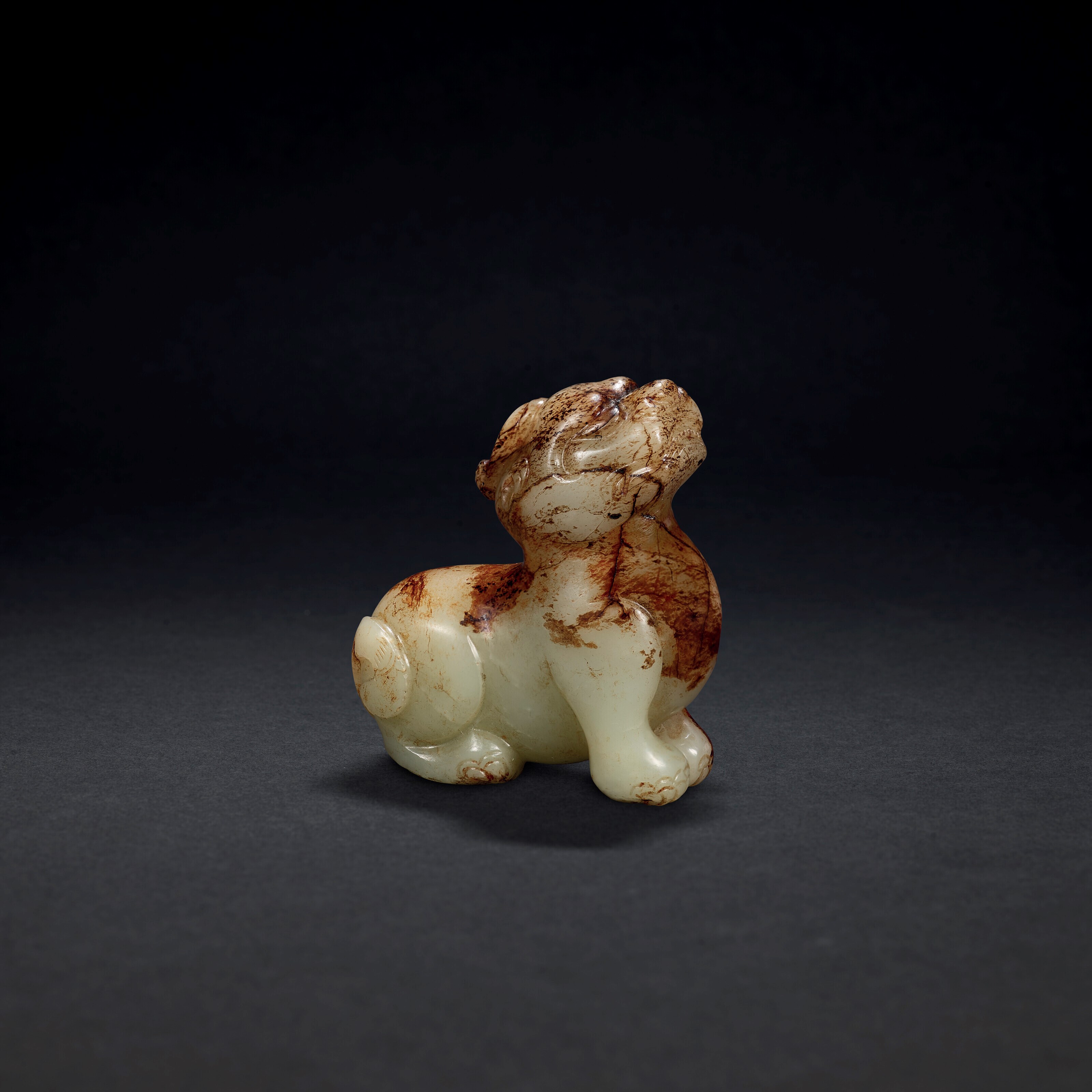 A CELADON AND RUSSET JADE BIXIE
