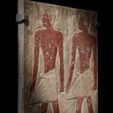 AN EGYPTIAN POLYCHROME LIMESTONE RELIEF FRAGMENT