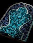 A CARVED AND GLAZED TIMURID POTTERY TILE
