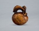A CARVED WOOD NETSUKE OF LOTUS LEAVES FORMING A MOKUGYO