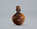 A CARVED WOOD NETSUKE OF LOTUS LEAVES FORMING A MOKUGYO