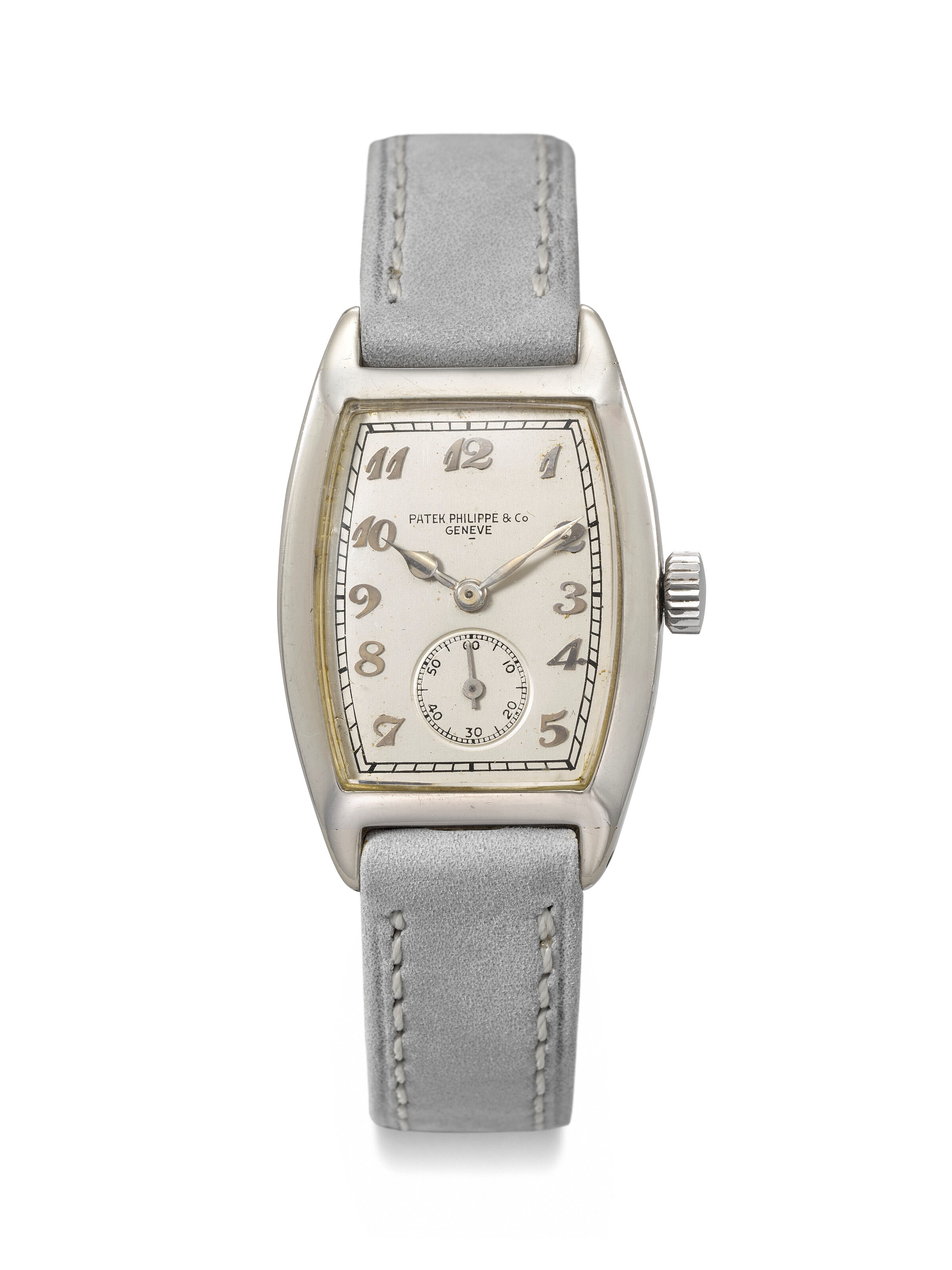 PATEK PHILIPPE. AN EARLY, ELEGANT AND LARGE 18K WHITE GOLD TONNEAU-SHAPED WRISTWATCH WITH BREGUET NUMERALS