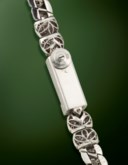 CARTIER. AN ELEGANT AND EYE-CATCHING PLATINUM AND DIAMOND-SET COCKTAIL BRACELET WATCH WITH BAGUETTE BEZEL