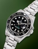 ROLEX. A SPORTY STAINLESS STEEL DUAL TIME AUTOMATIC WRISTWATCH WITH DATE AND BRACELET